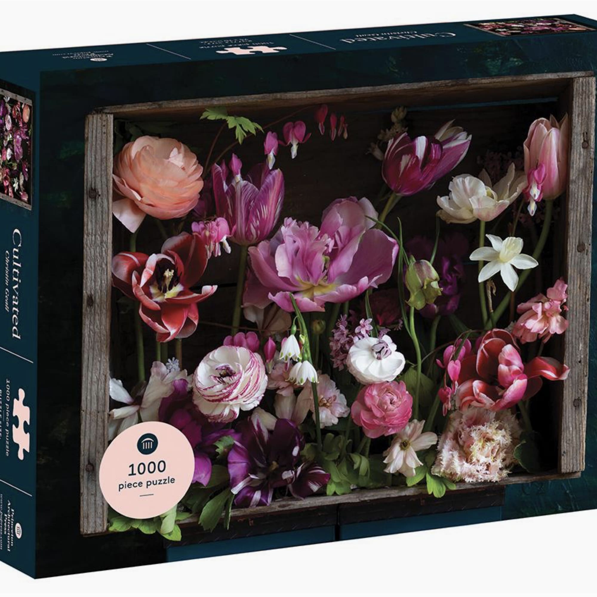 Box of a floral puzzle with pink and white flowers in a wooden frame