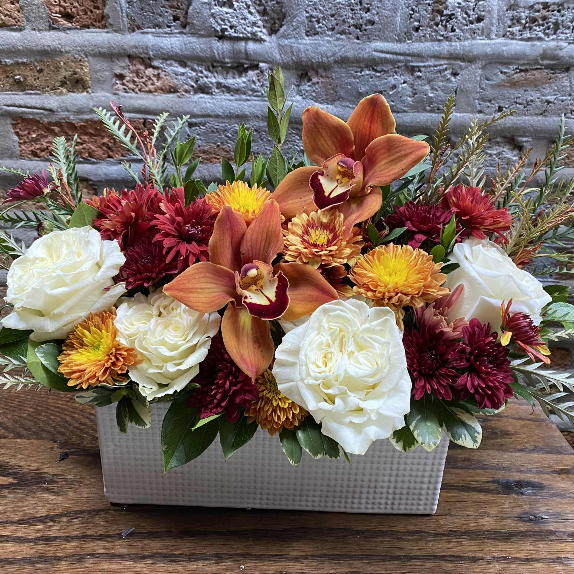 Fall florals, orchids and greens in a modern design in a low, photo 2 of 2