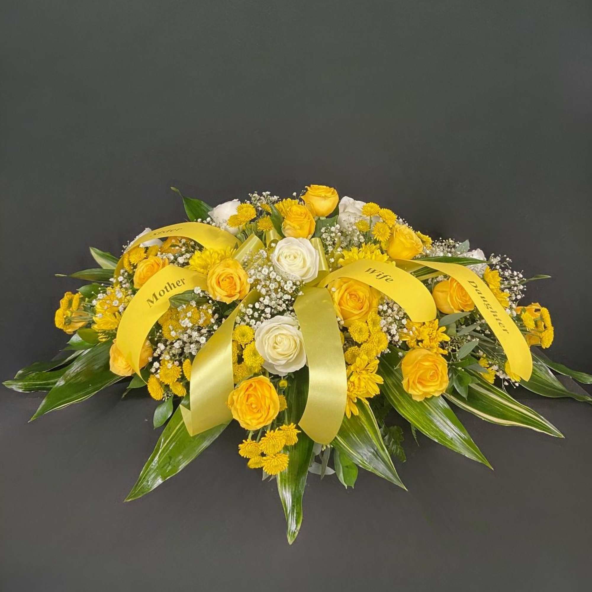 Golden yellow roses become even more striking against a backdrop of elegant