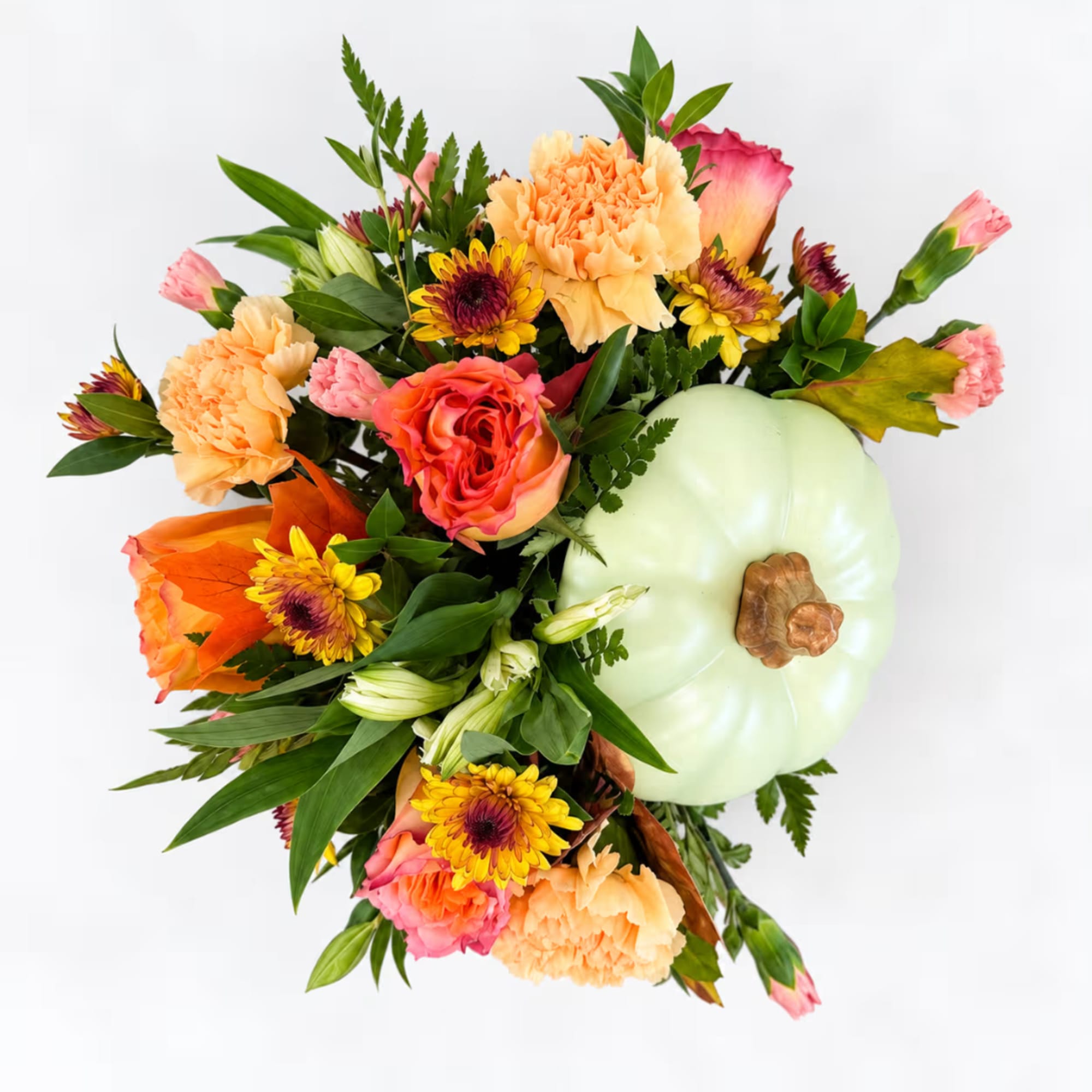 Bouquet with peach carnations, pink roses, and a pale green pumpkin accent