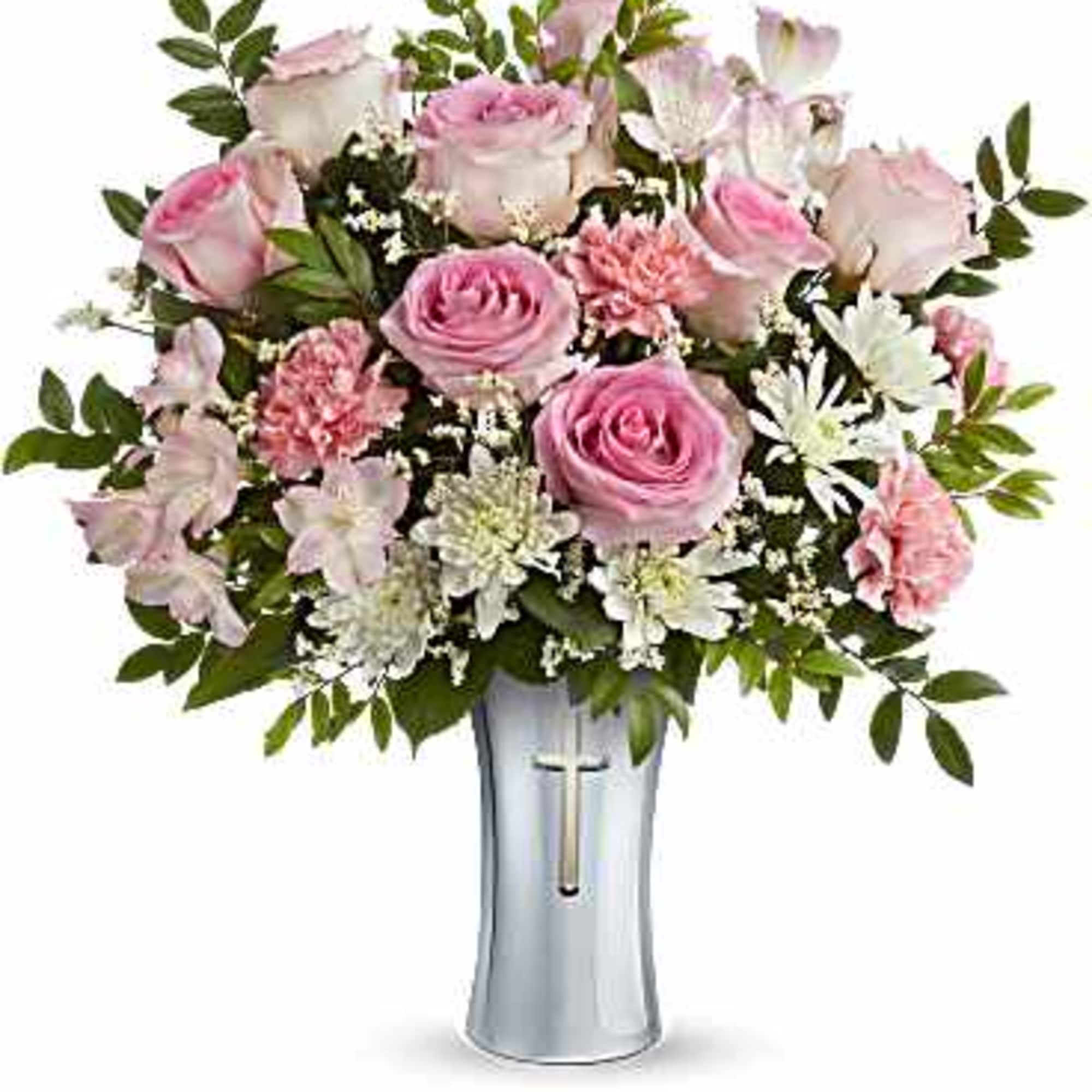 Pink roses and white flowers arranged in a silver vase