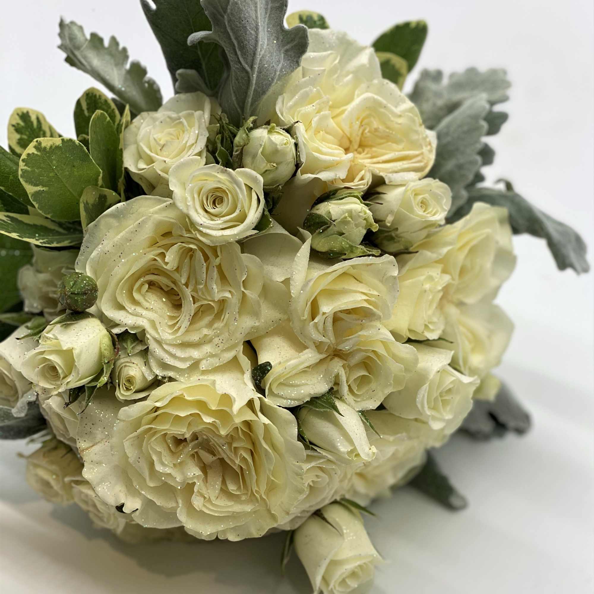 A lush mix of whites and creams, with dusty miller accent and, photo 3 of 4