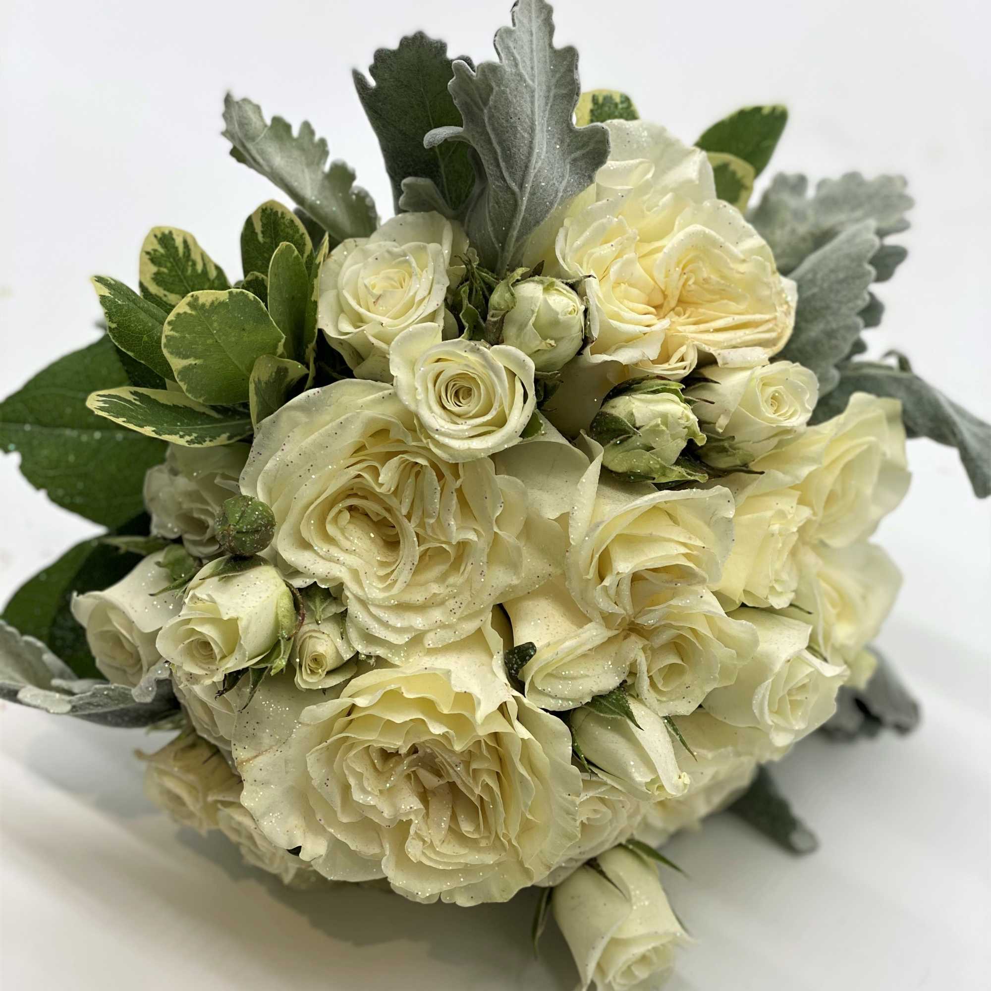 A lush mix of whites and creams, with dusty miller accent and, photo 4 of 4