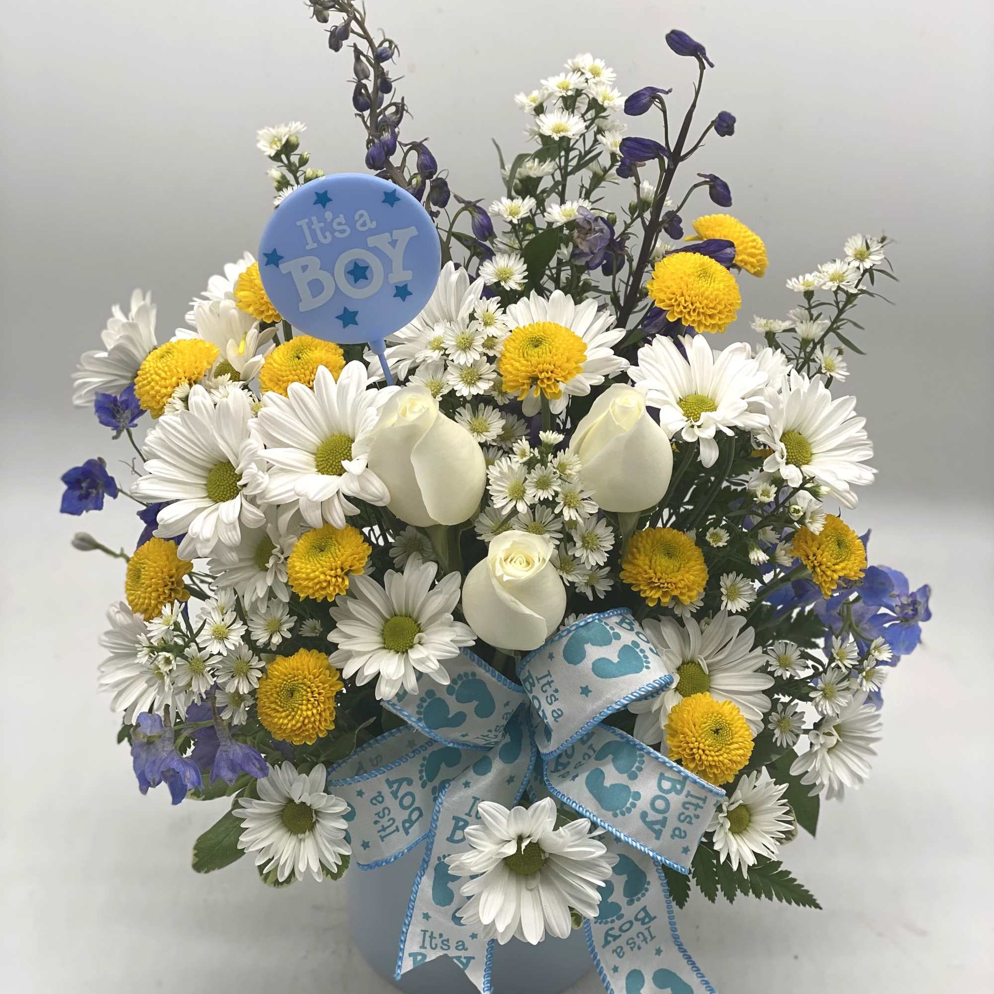 Bouquet of white daisies and yellow mums with a blue "It's a Boy" pick