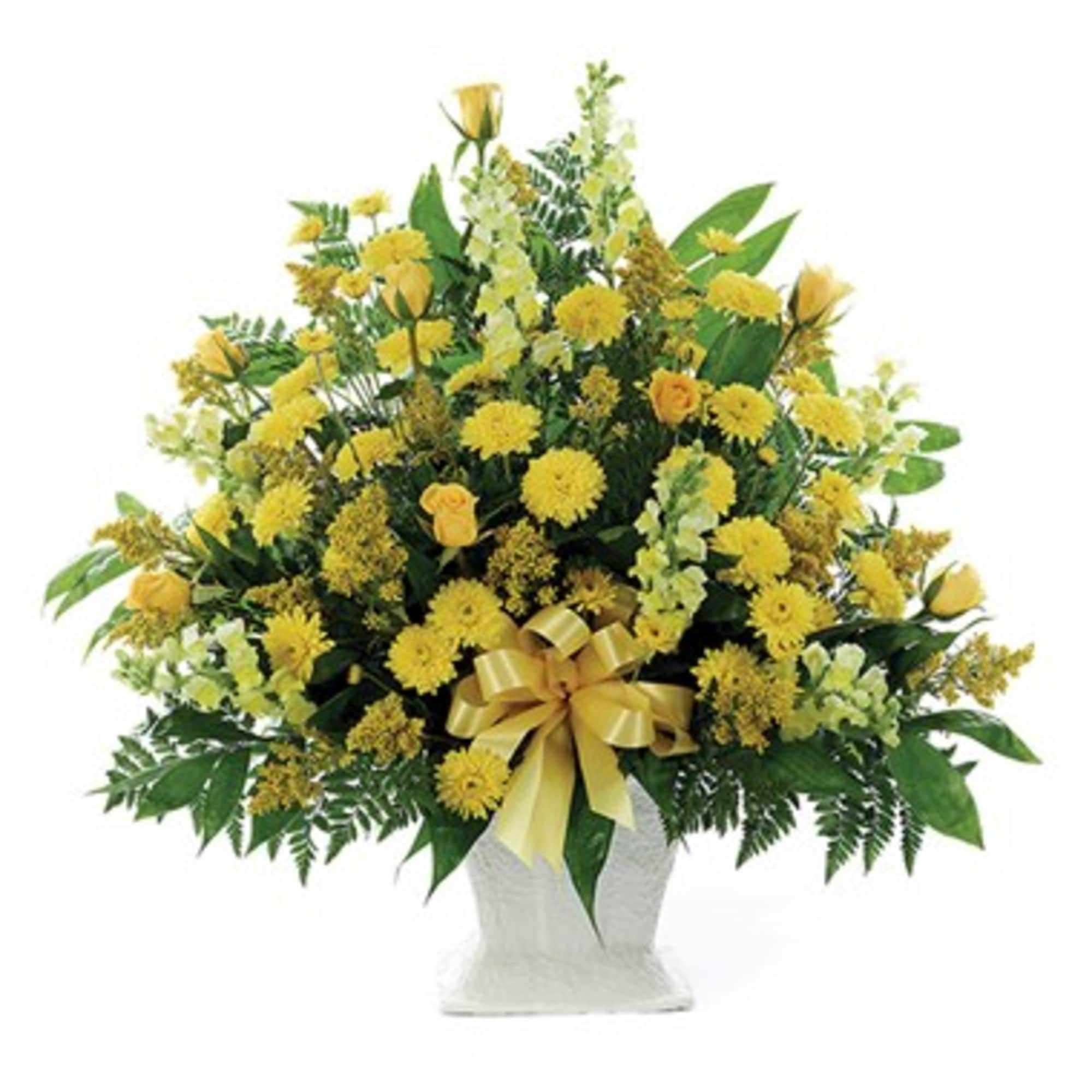 Yellow mixed flower arrangement in a white vase with a gold bow