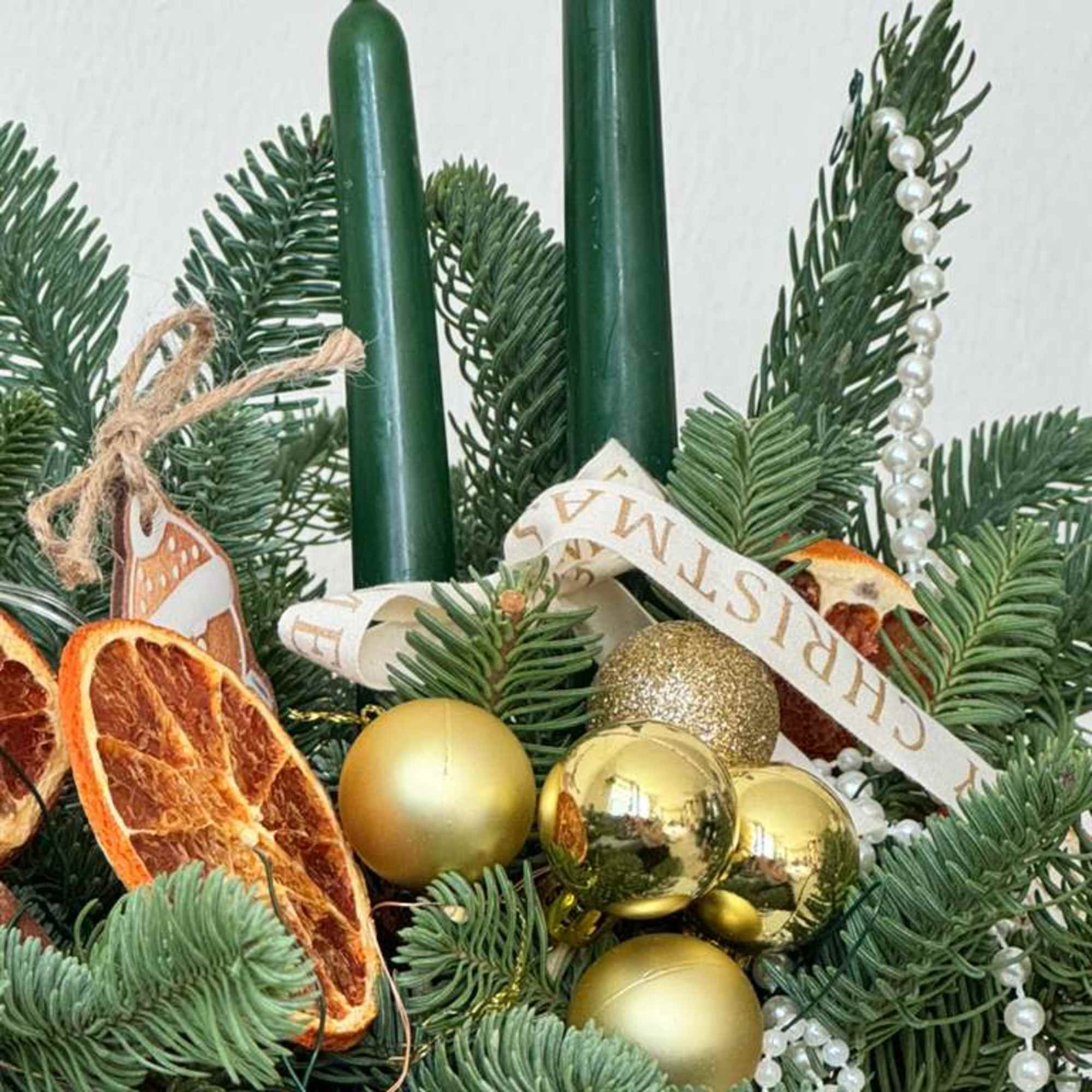 A cozy holiday centerpiece made with fresh fragrant evergreen, paired with tall, photo 2 of 3