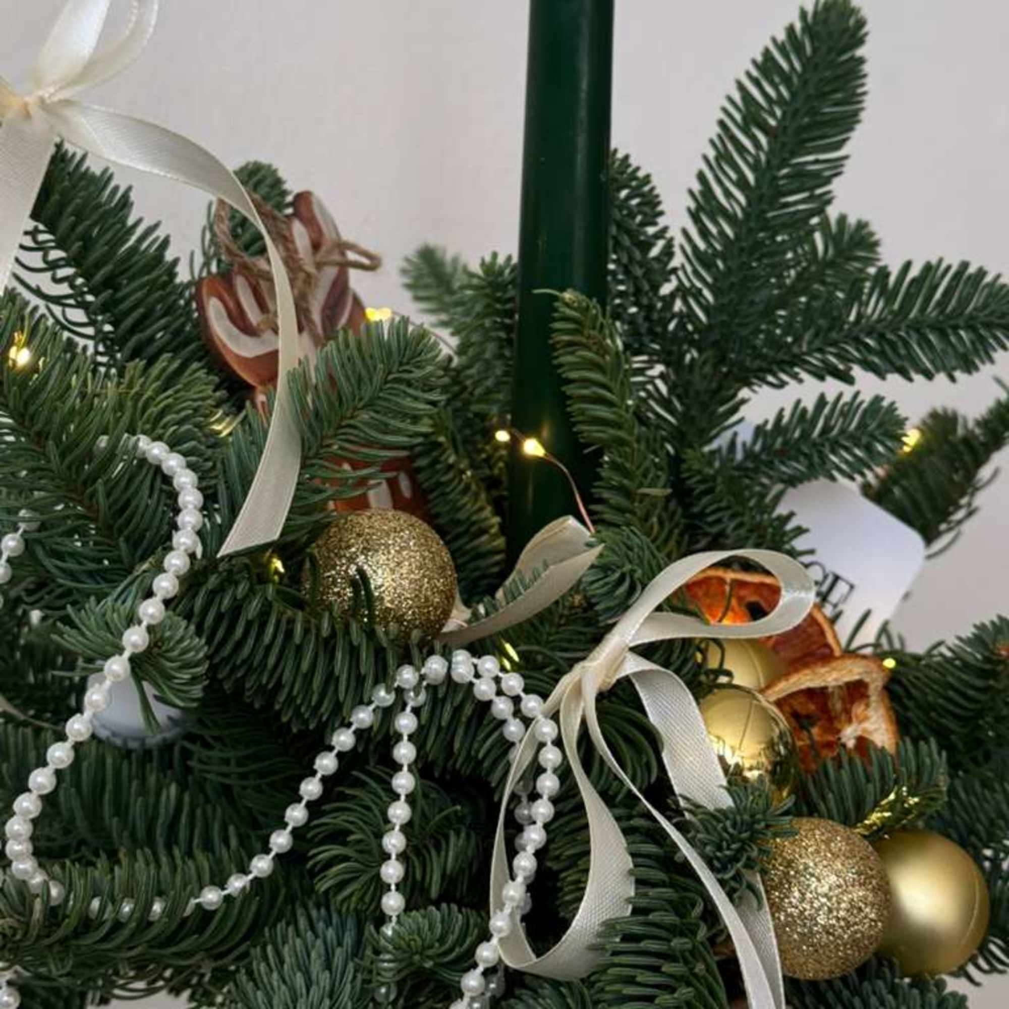 A festive holiday centerpiece made with fresh, fragrant evergreen in a gold, photo 2 of 3