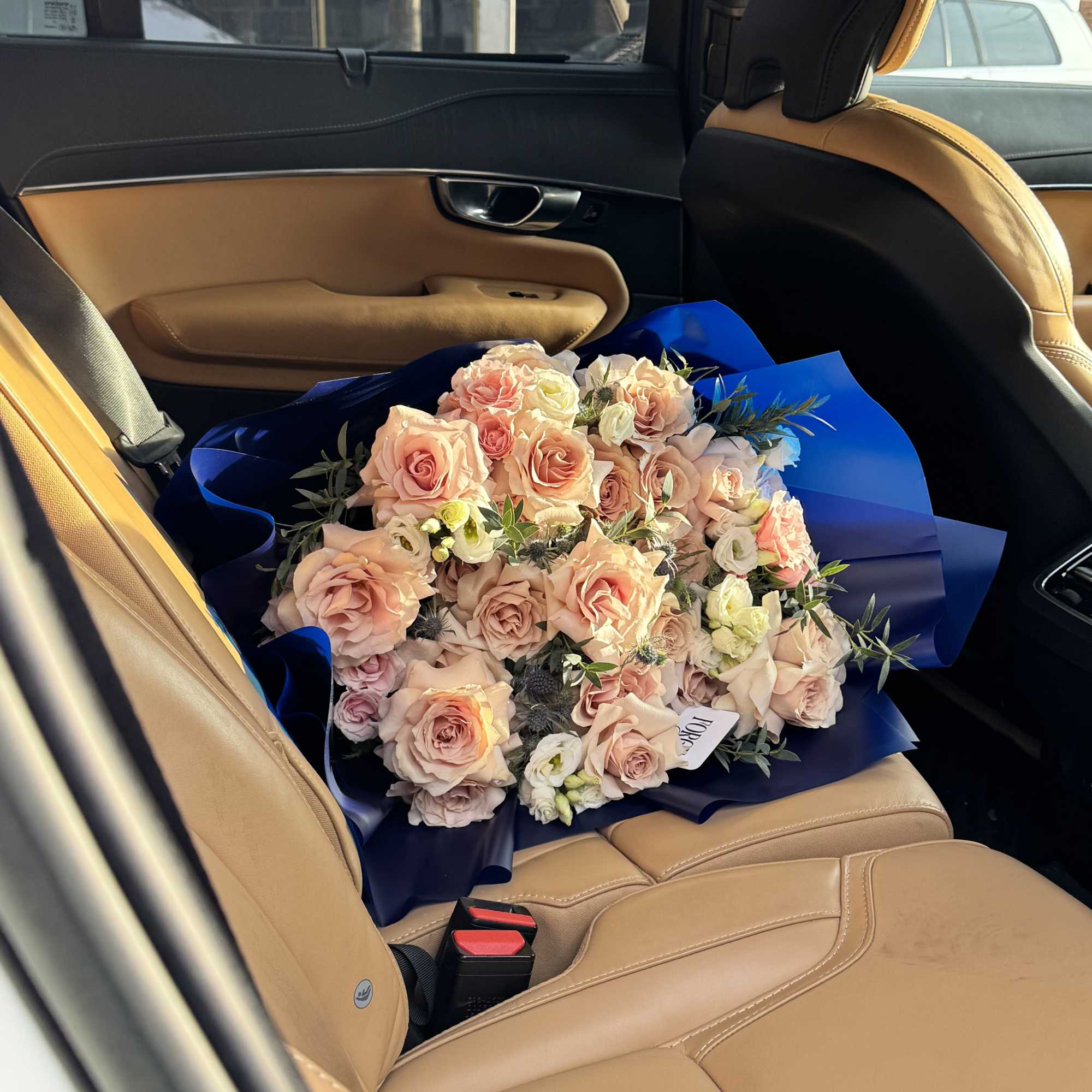 A luxe, romantic bouquet of 25 peach-blush roses with soft white lisianthus, photo 2 of 2