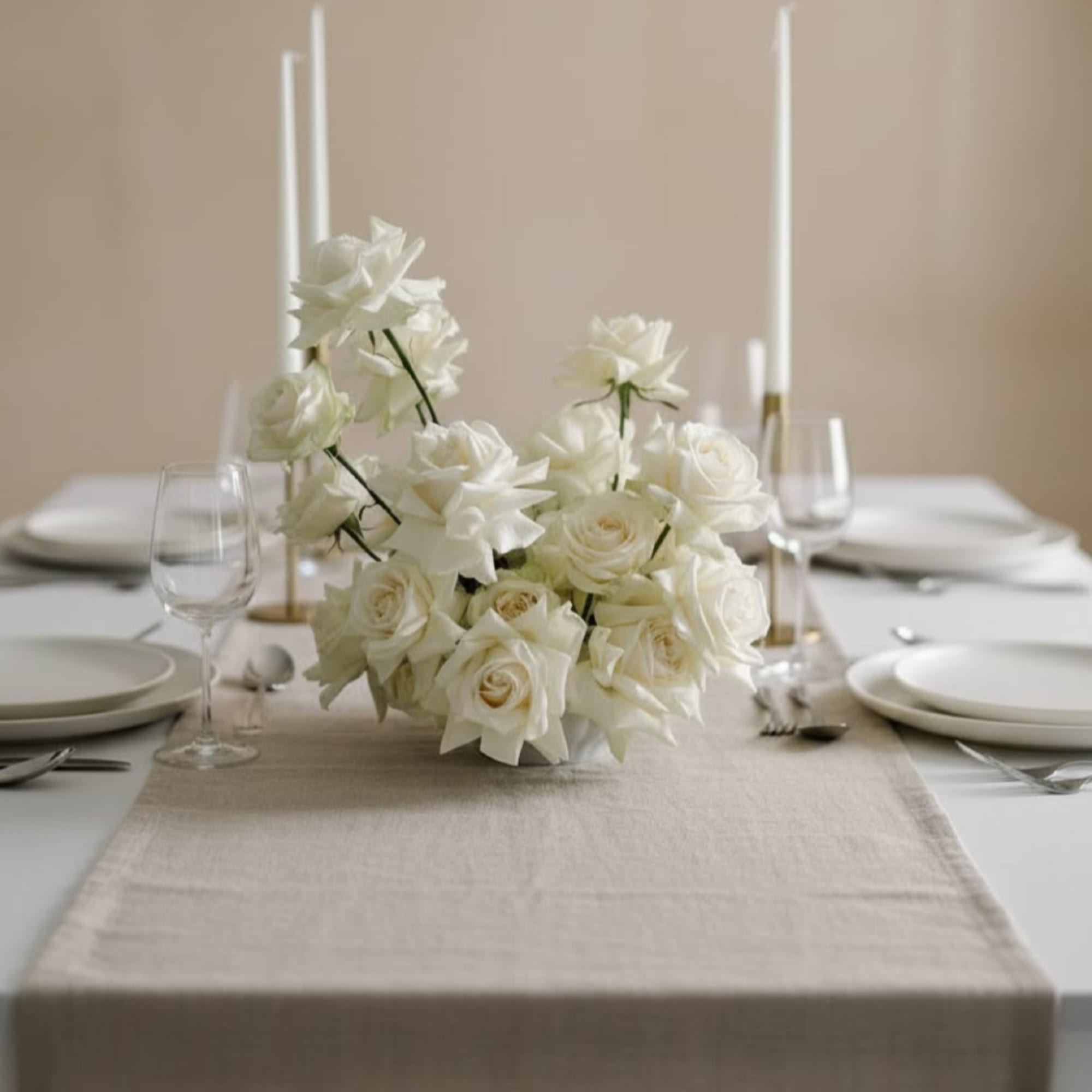 White rose and calla lily centerpiece on a set dining table
