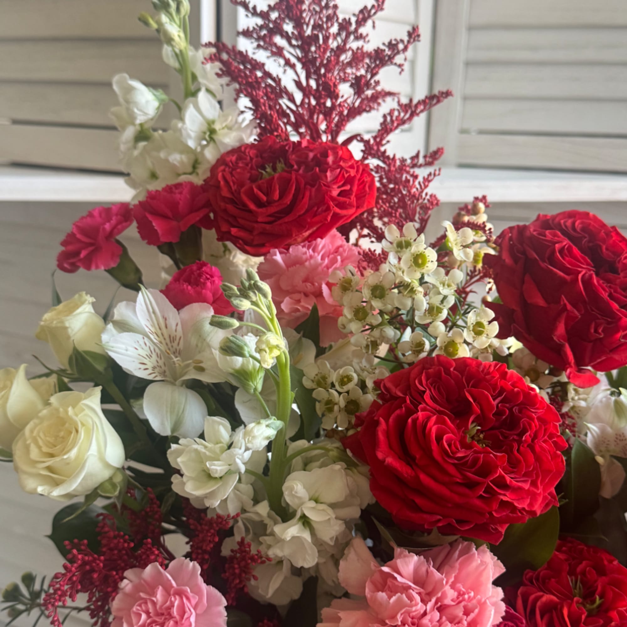 Bouquet of red and pink roses with white and pink flowers