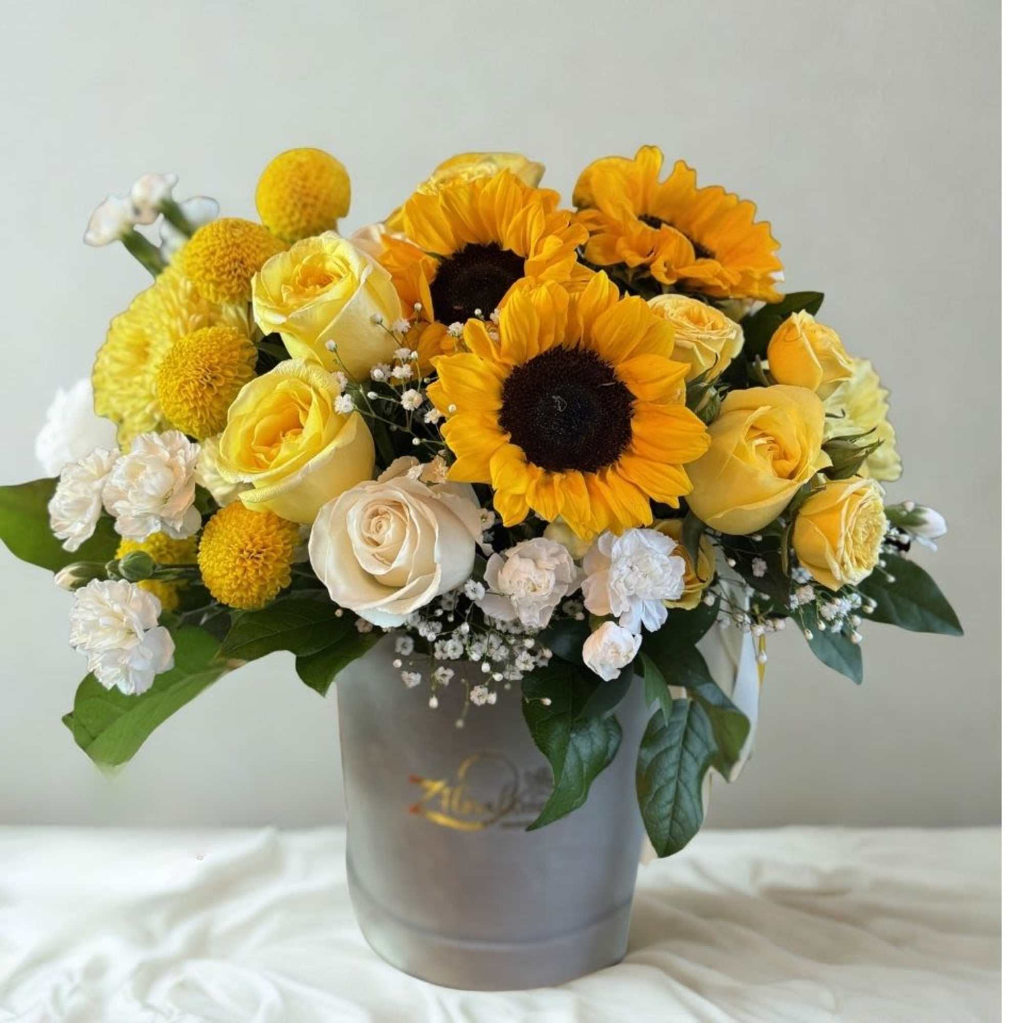 Exude warmth and elegance with a curated mix of premium yellow blooms.