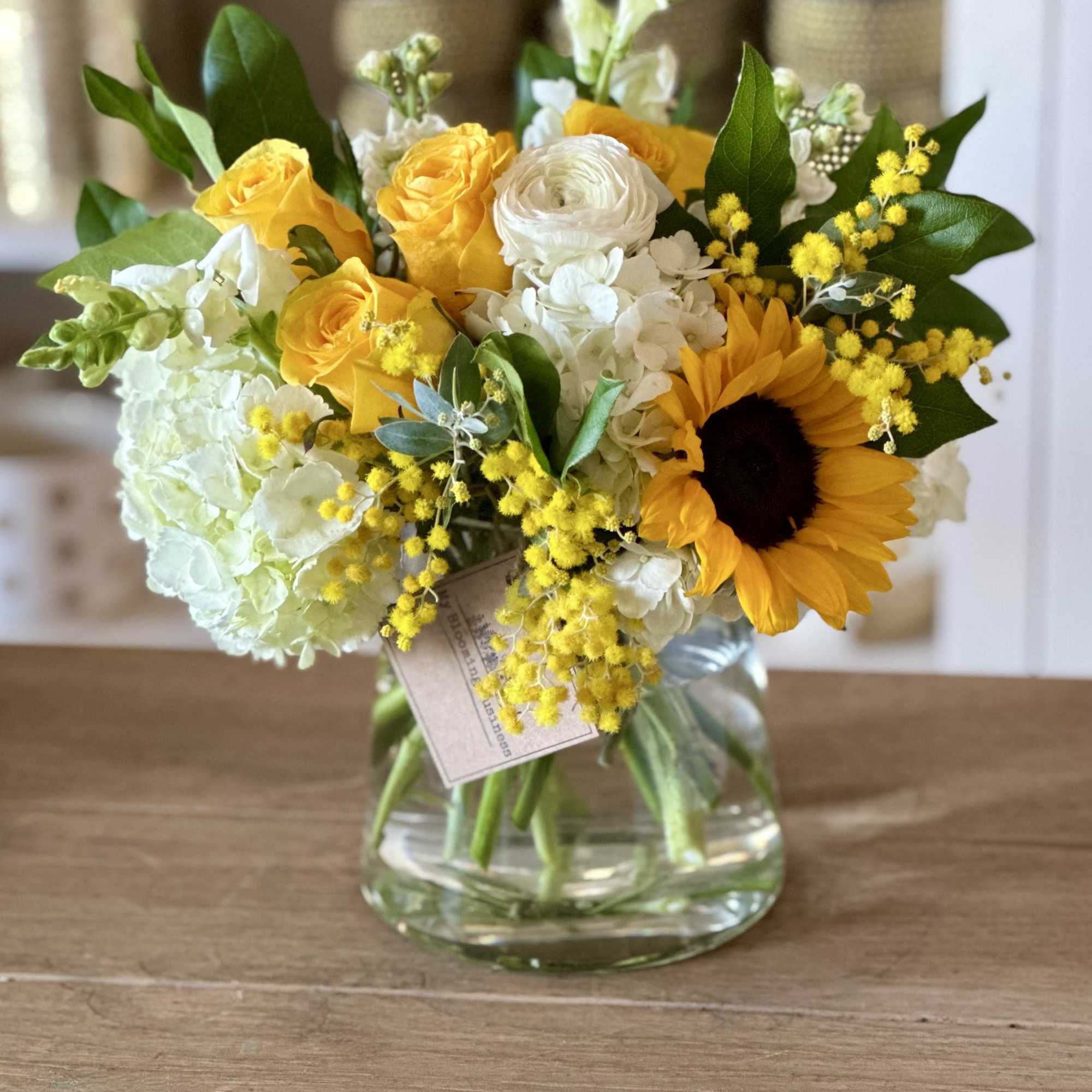 Yellow and white mixed bouquet in a clear glass vase