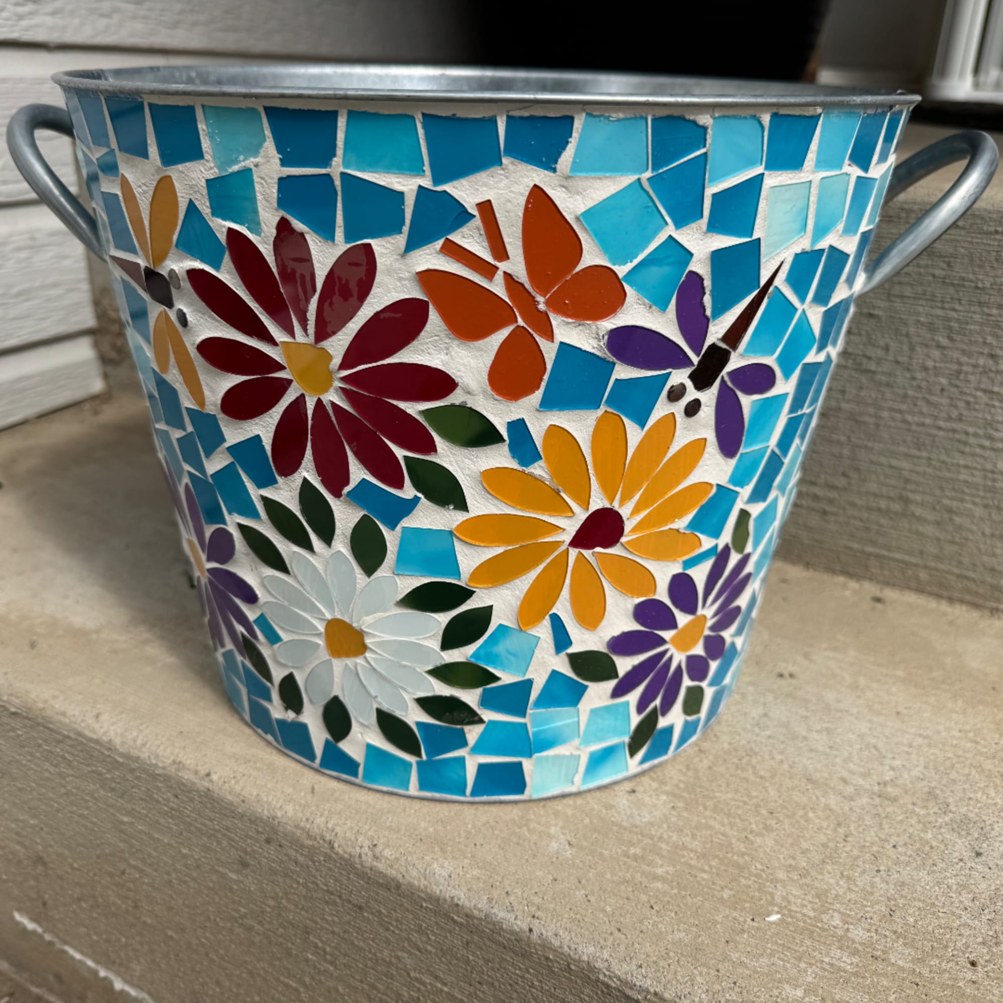 Mosaic metal bucket with colorful flower and butterfly designs