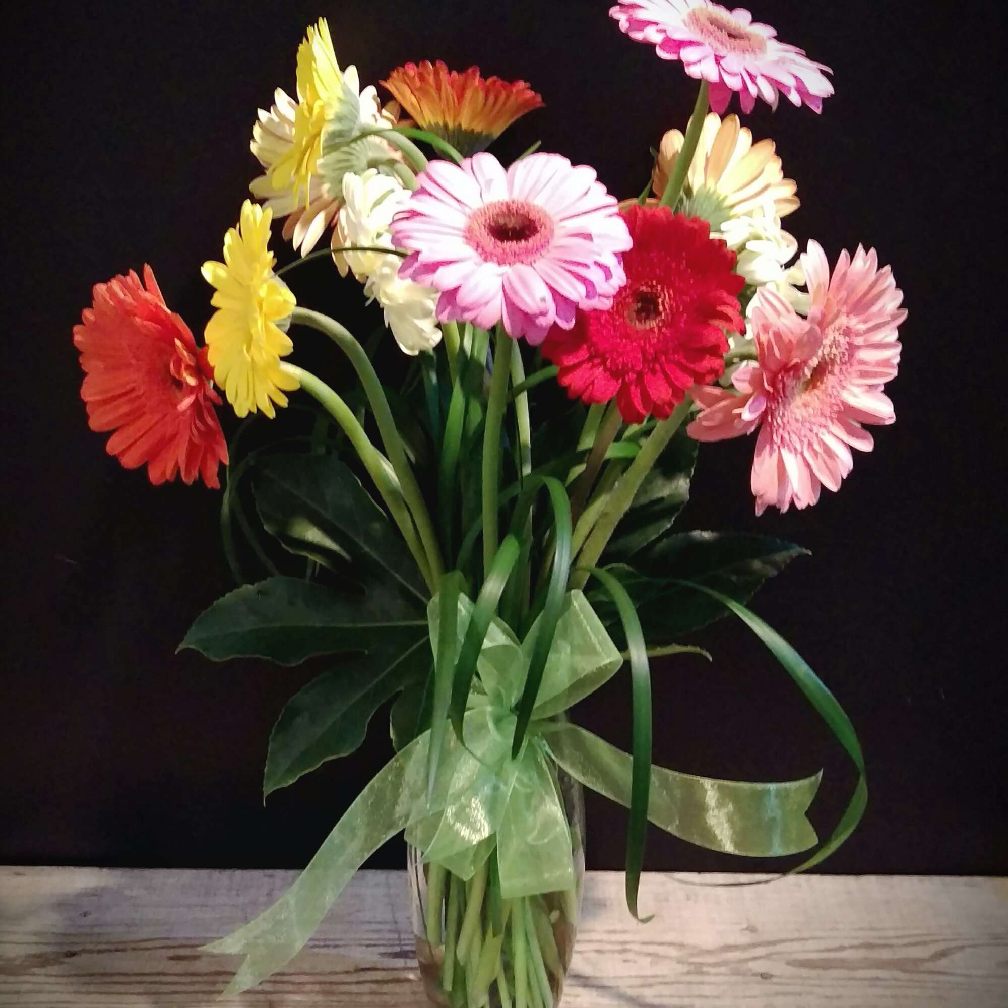 Bouquet of colorful gerbera daisies in a glass vase
