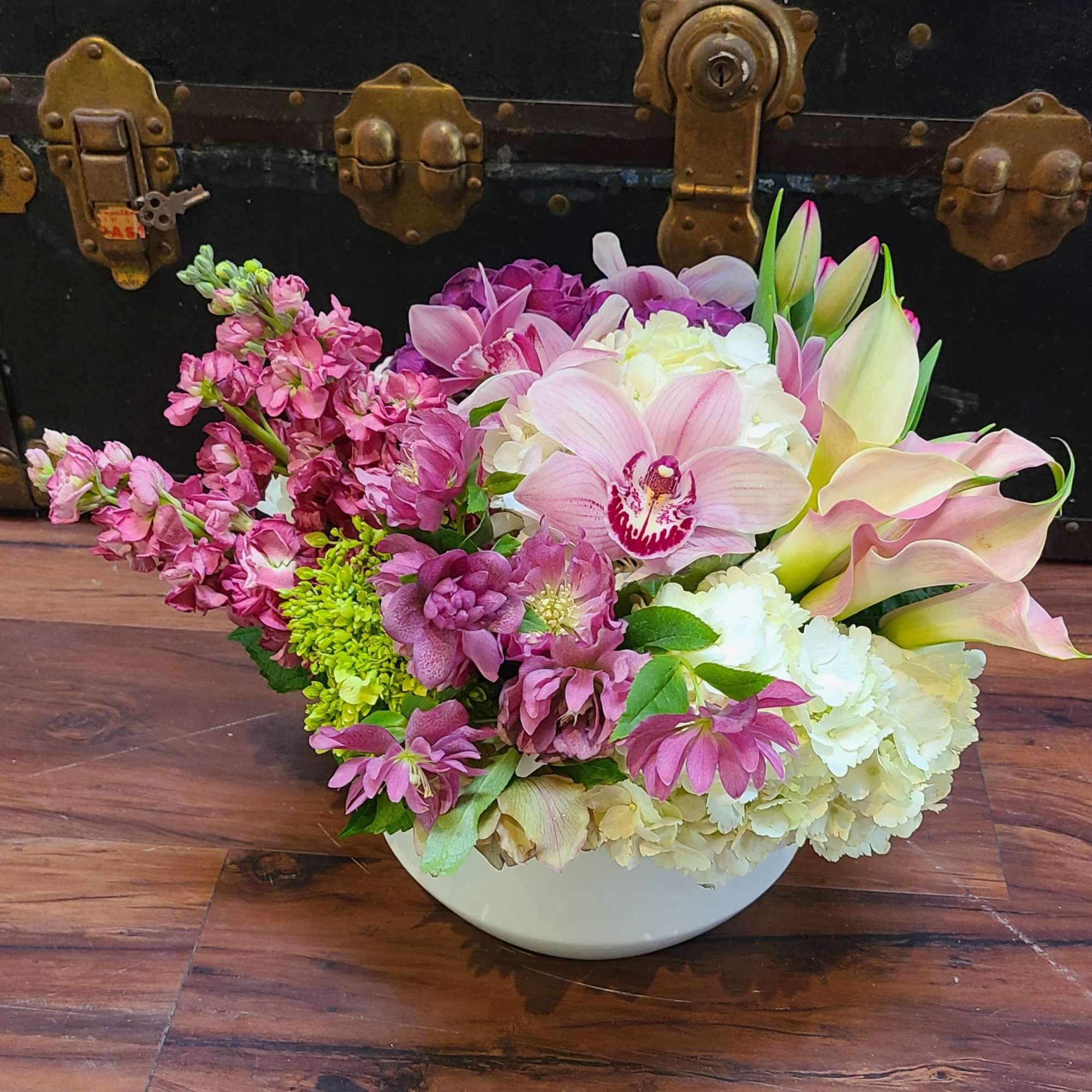 This is a low centerpiece featuring a variety of pink, mauve, and, photo 2 of 2