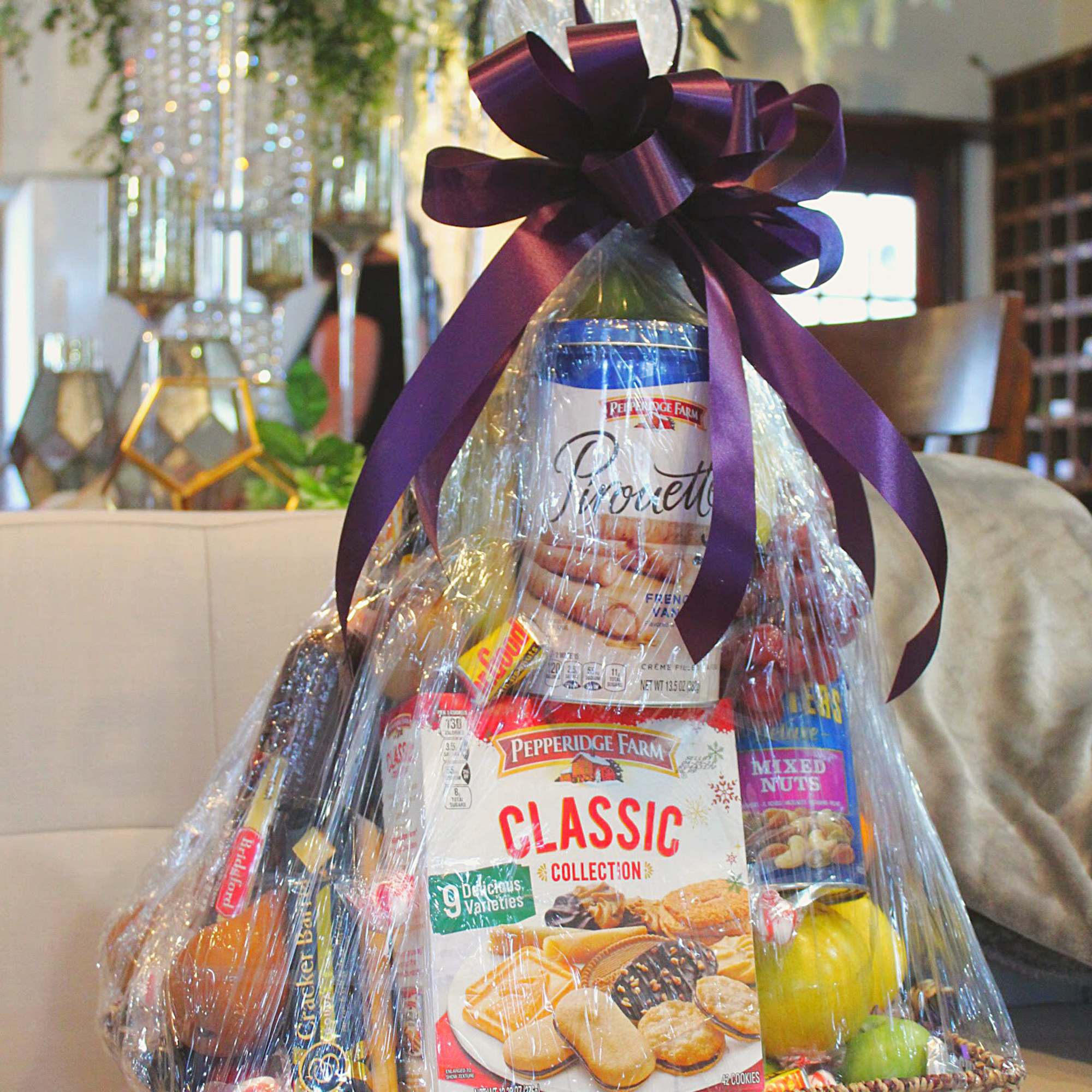 Gift basket with assorted cookies and snacks wrapped in clear cellophane
