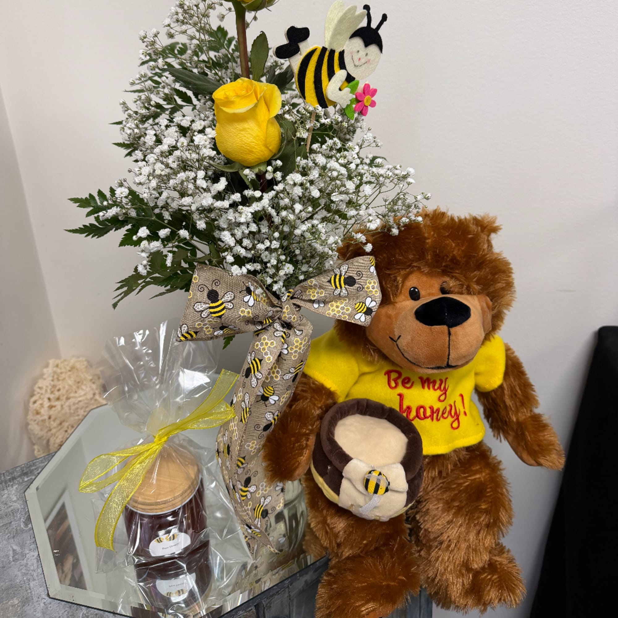 Yellow rose arrangement with a bee-themed teddy bear and honey jar gift