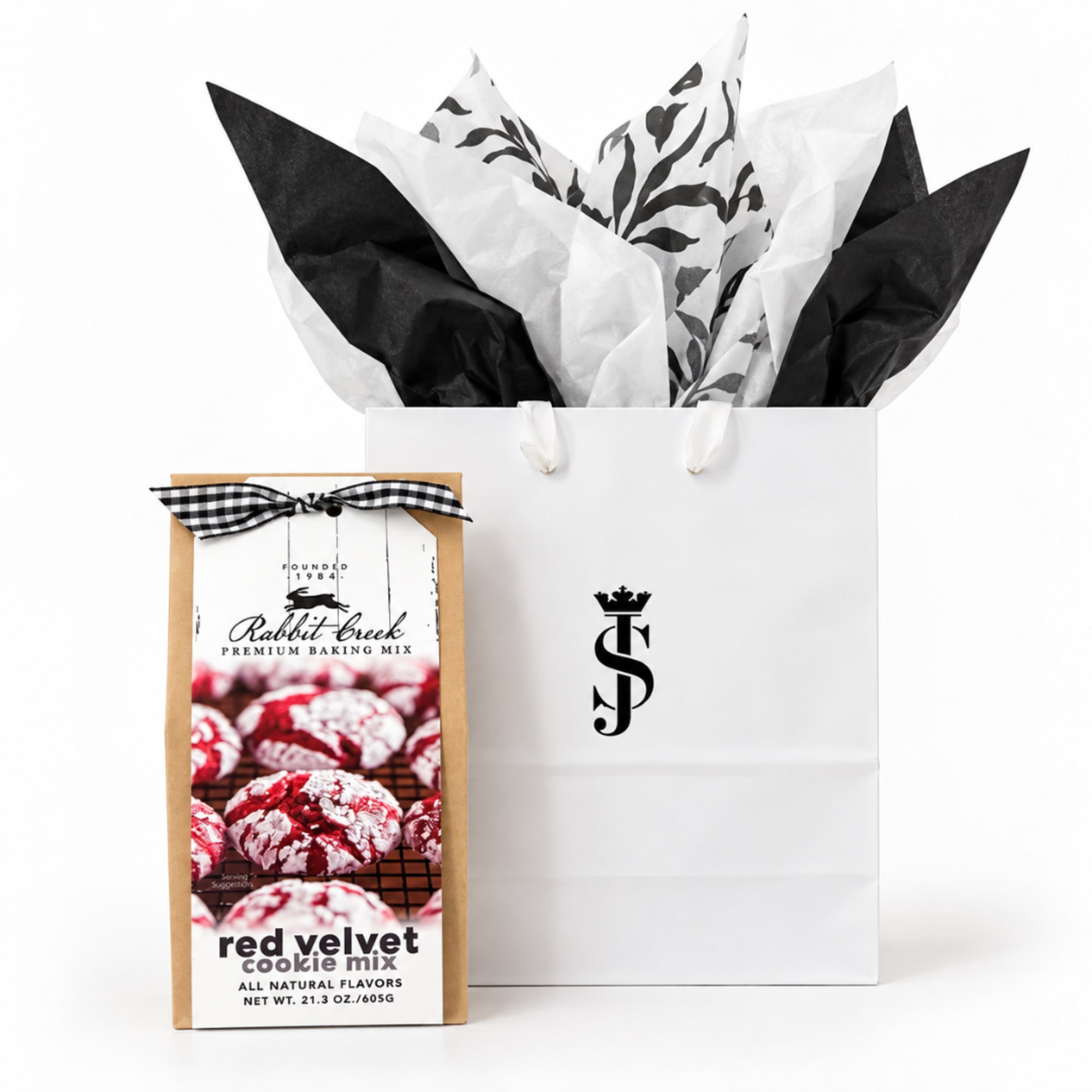 Gift bag with tissue paper and a cookie mix box beside it