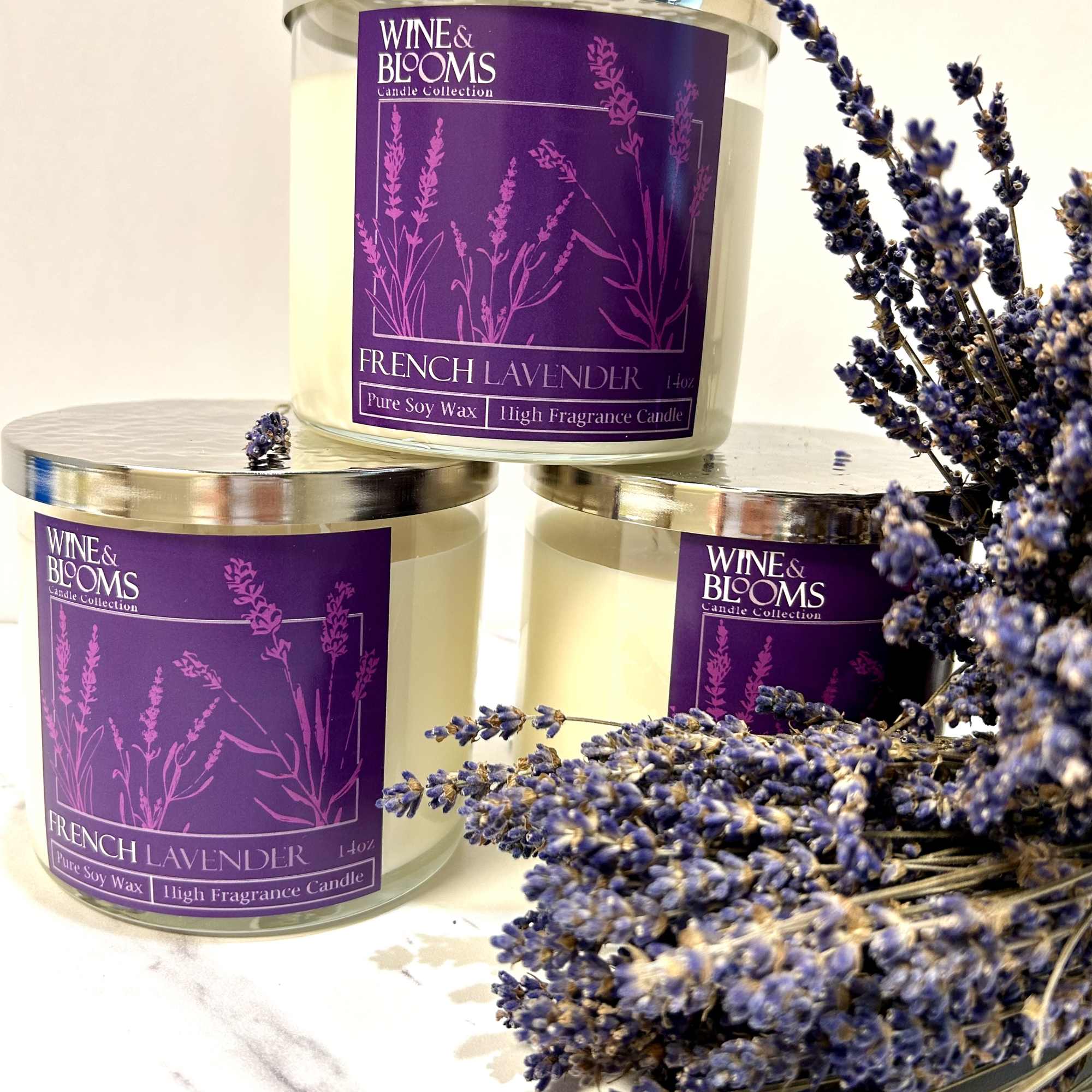 Three lavender-scented candles with a sprig of dried lavender