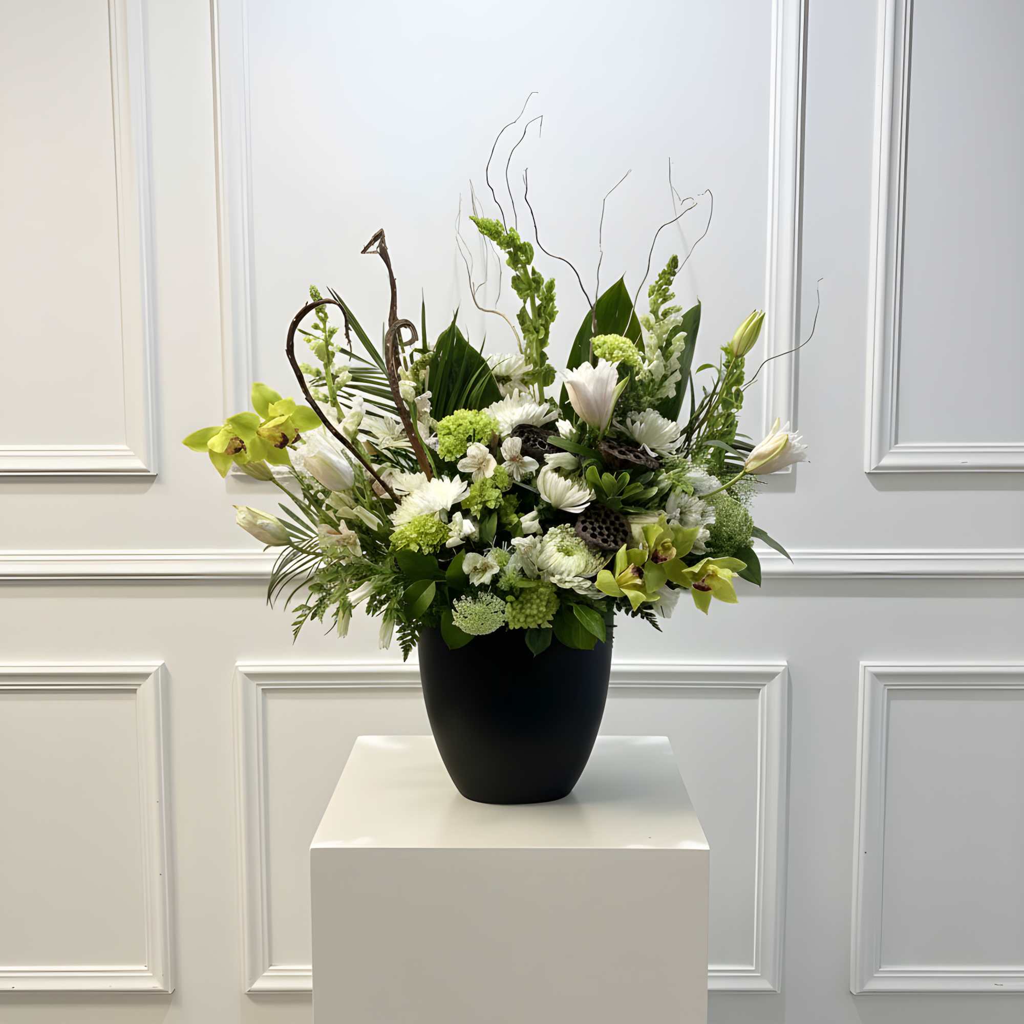 White and green floral arrangement in a black vase, photo 2 of 2