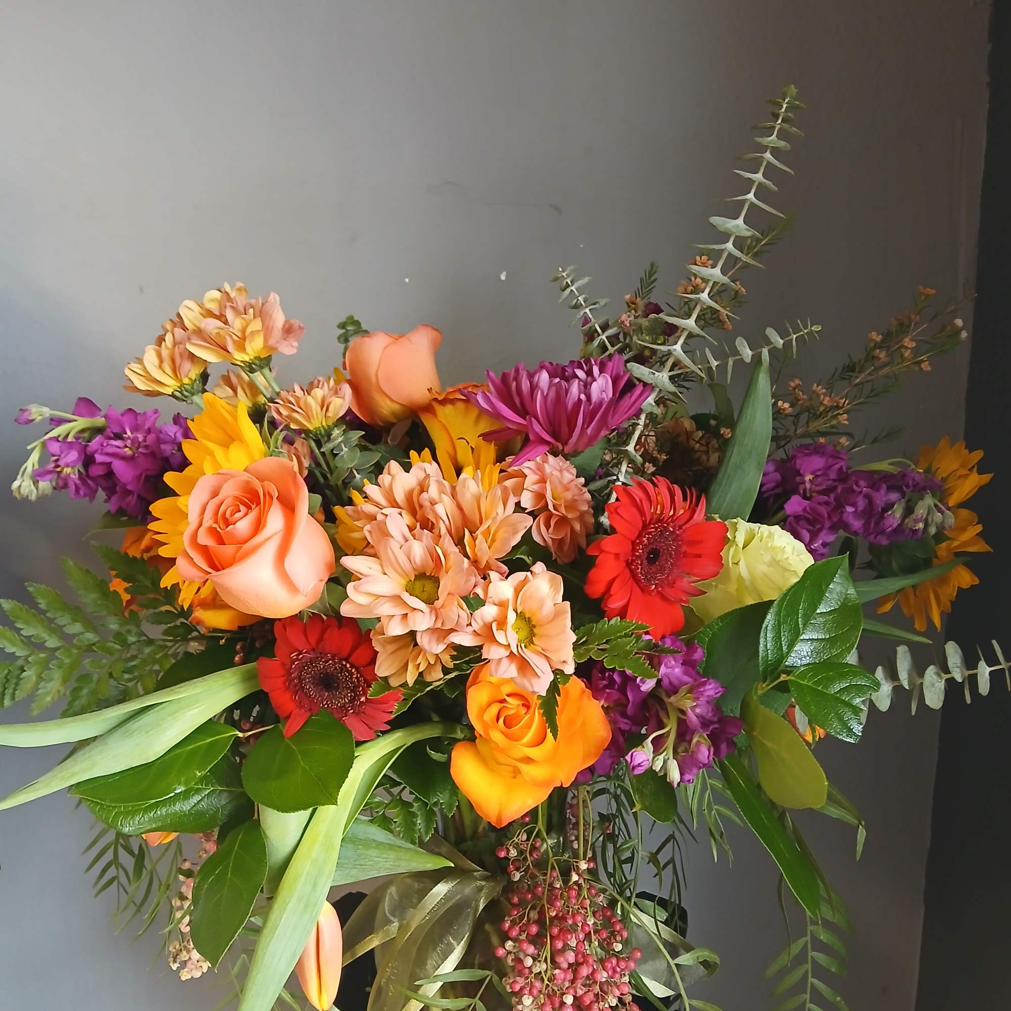 Colorful mixed bouquet with roses, gerbera daisies, and chrysanthemums in a vase