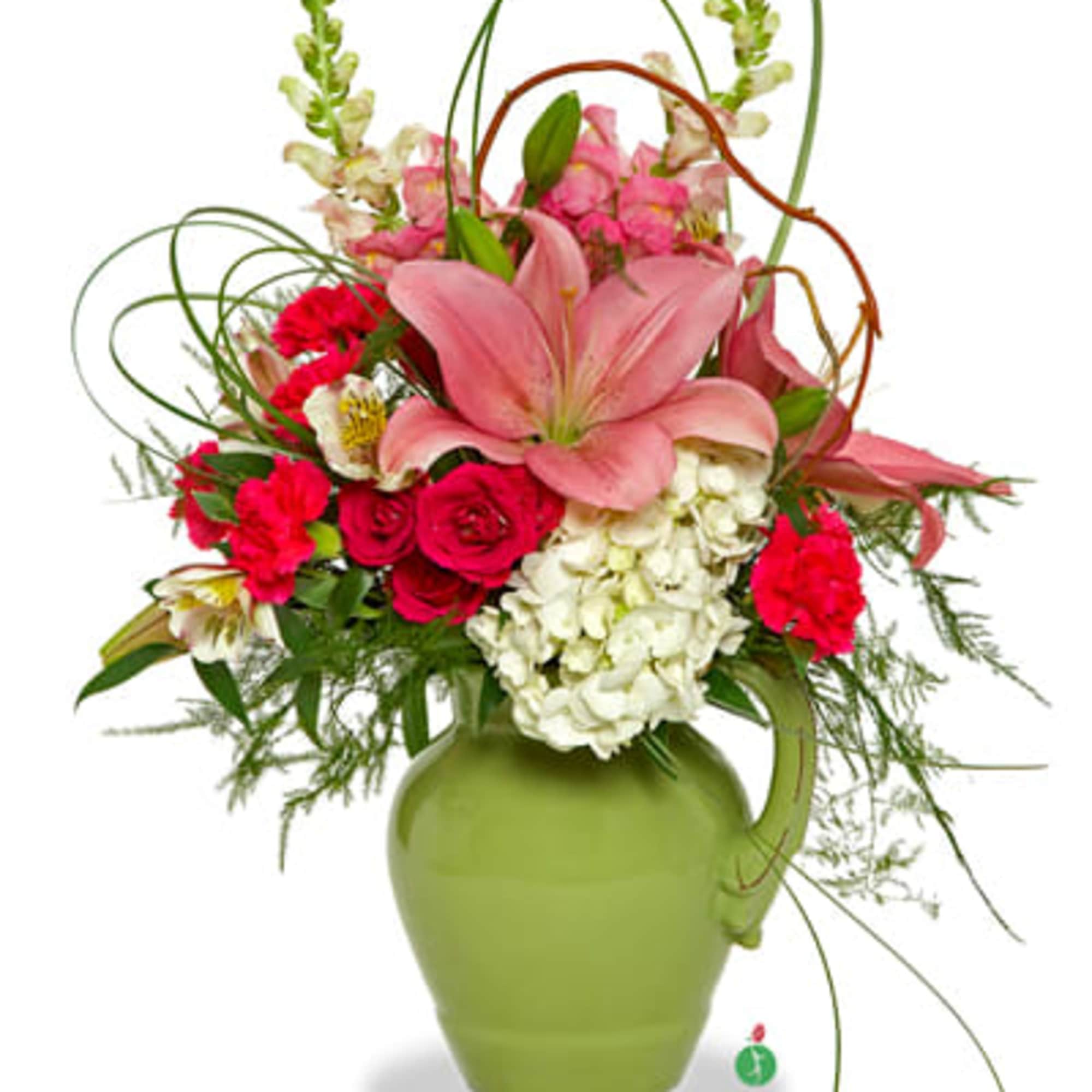 Pink lilies and roses arranged in a green vase