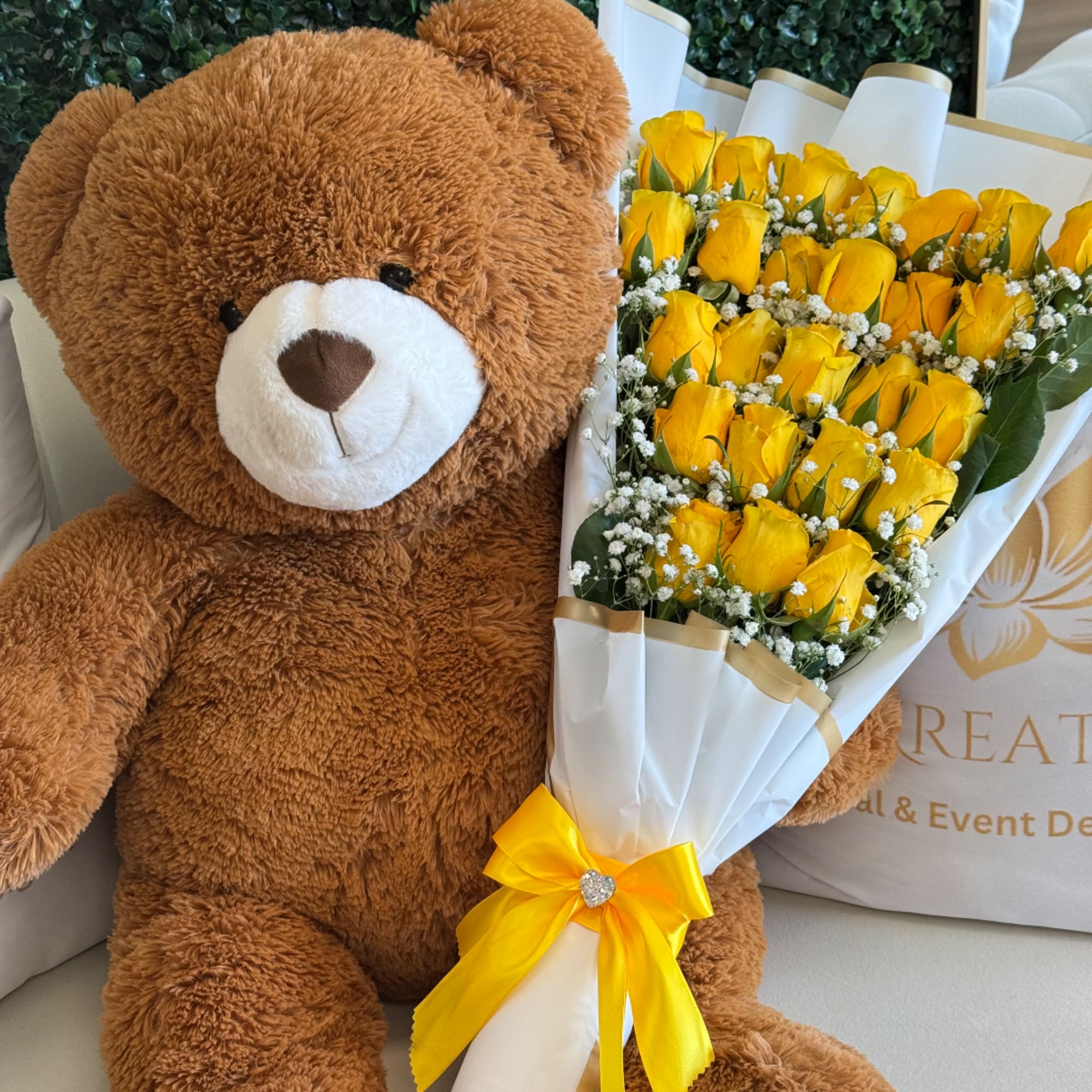 Teddy bear beside a bouquet of yellow roses wrapped in white paper, photo 2 of 4