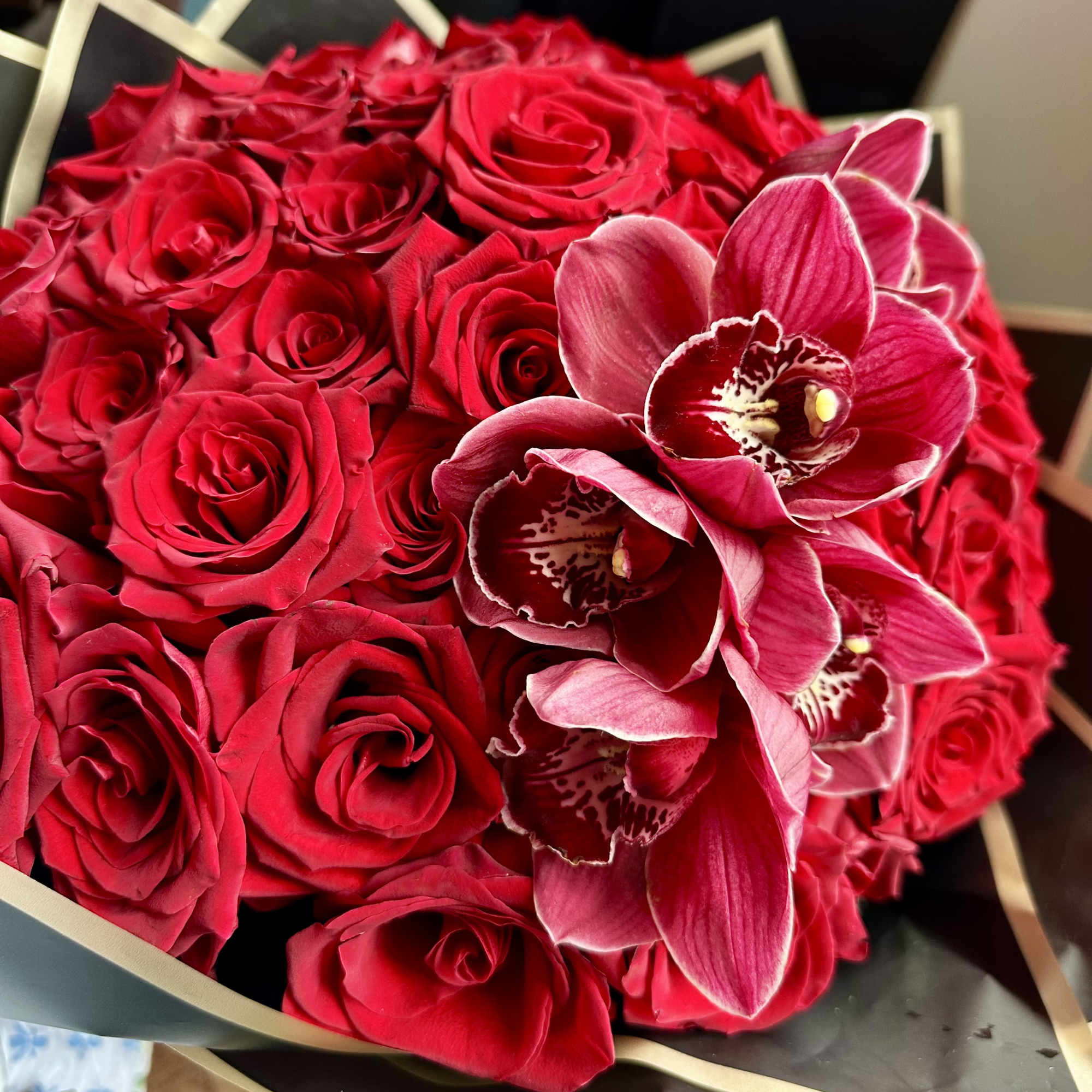 Bouquet of red roses with pink orchids