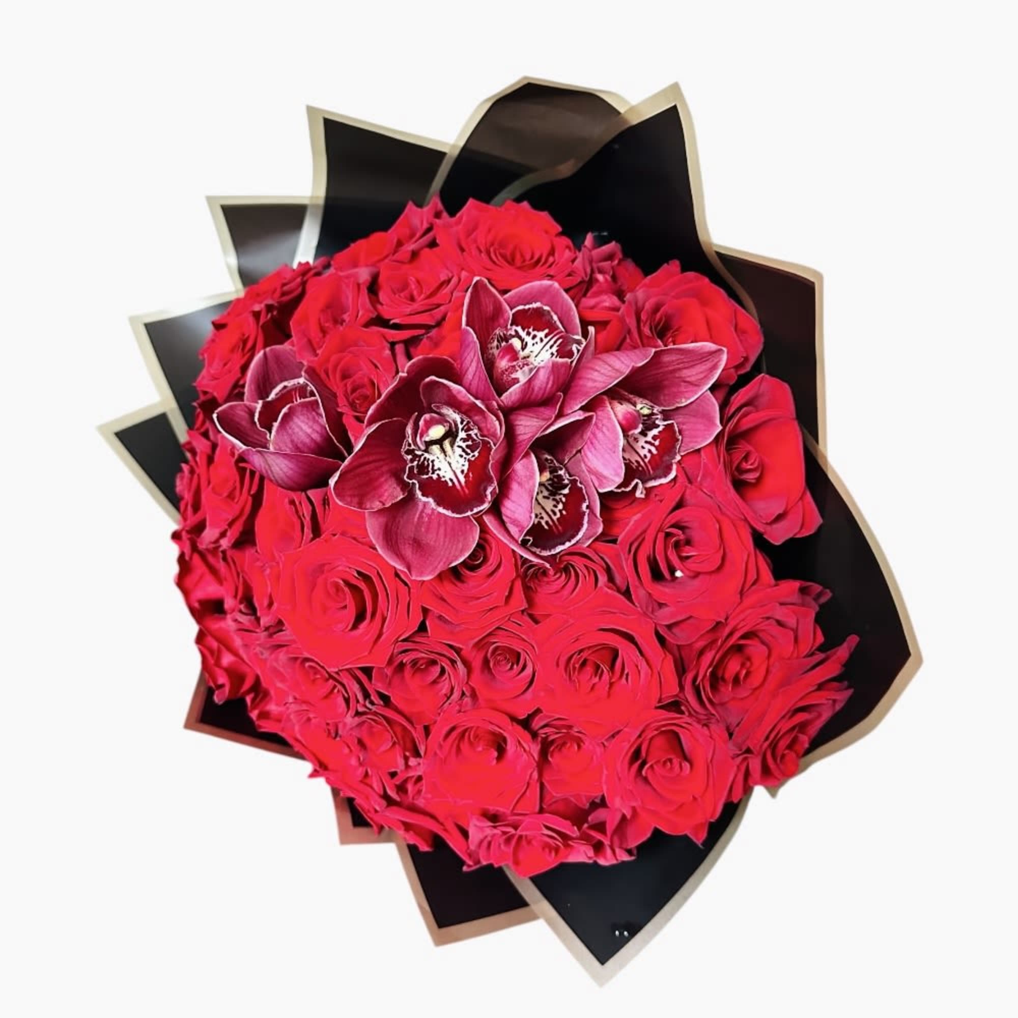 Bouquet of red roses with magenta orchids wrapped in black paper