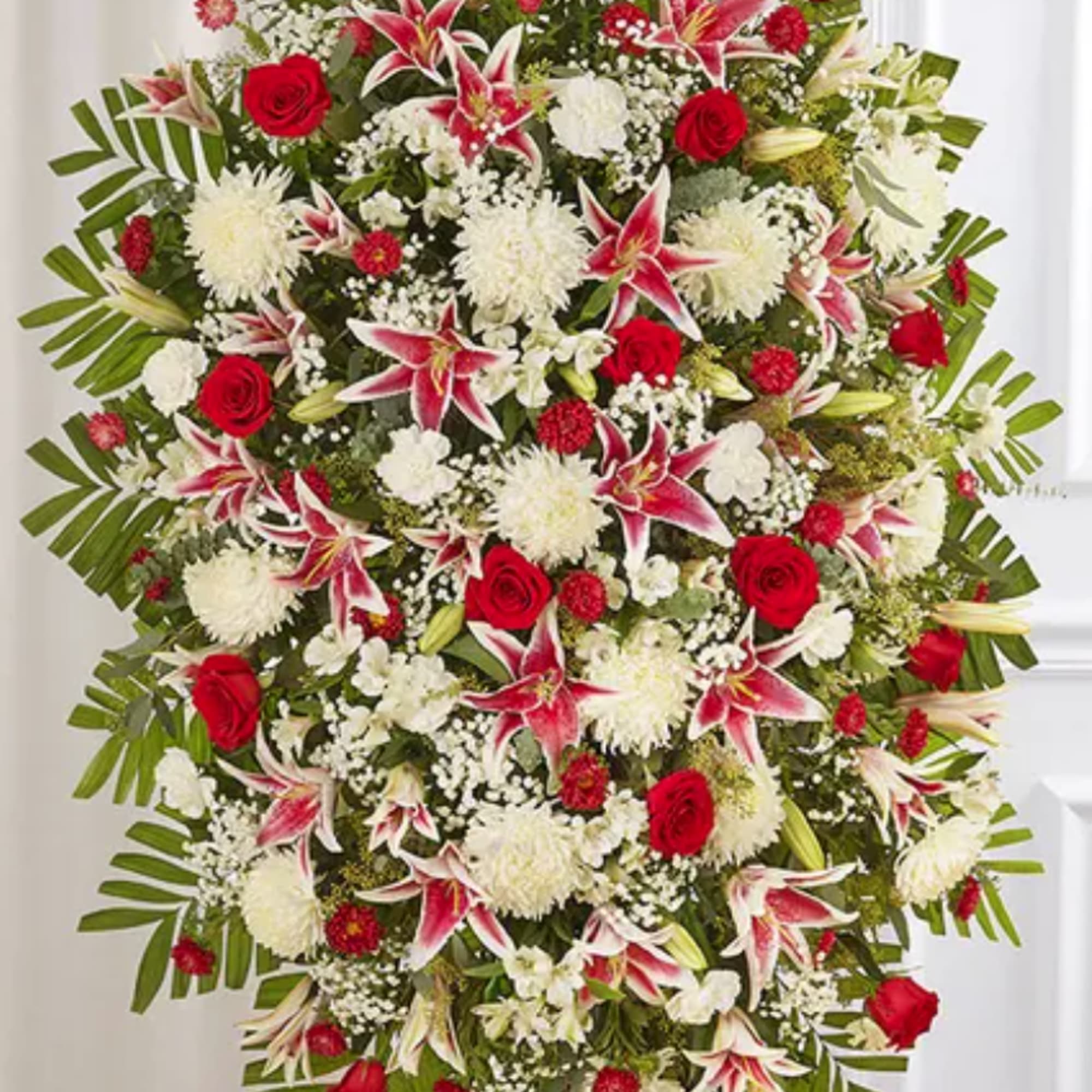 Large standing spray of red and white flowers on an easel