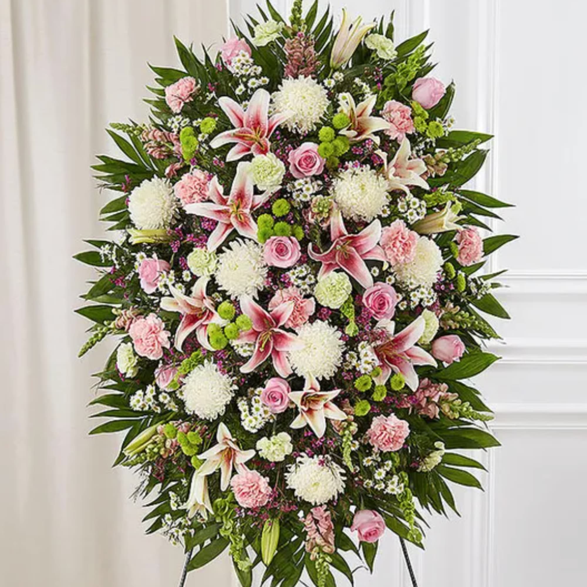 Standing floral spray with pink and white flowers on an easel