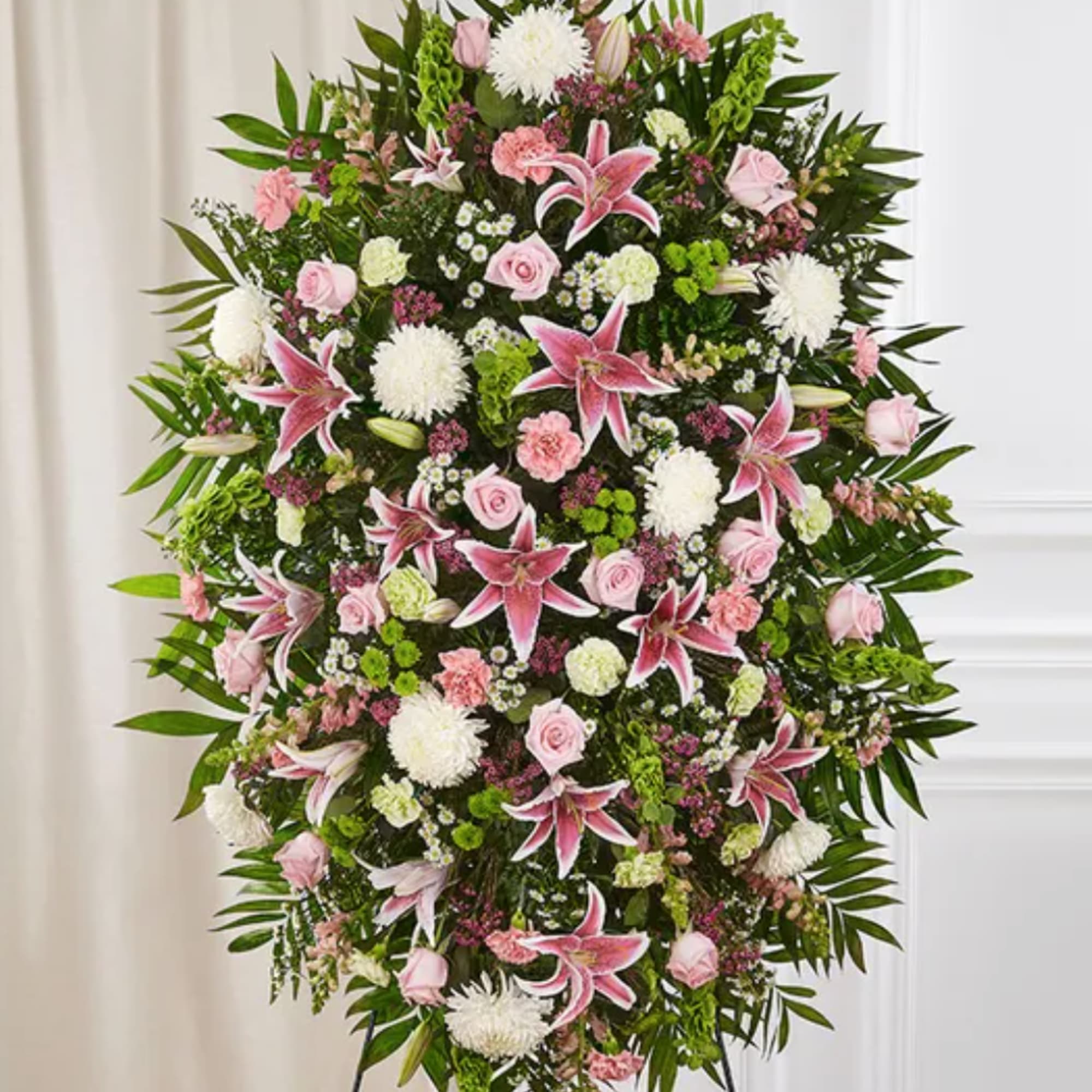 Standing floral spray with pink lilies, roses, and white blooms