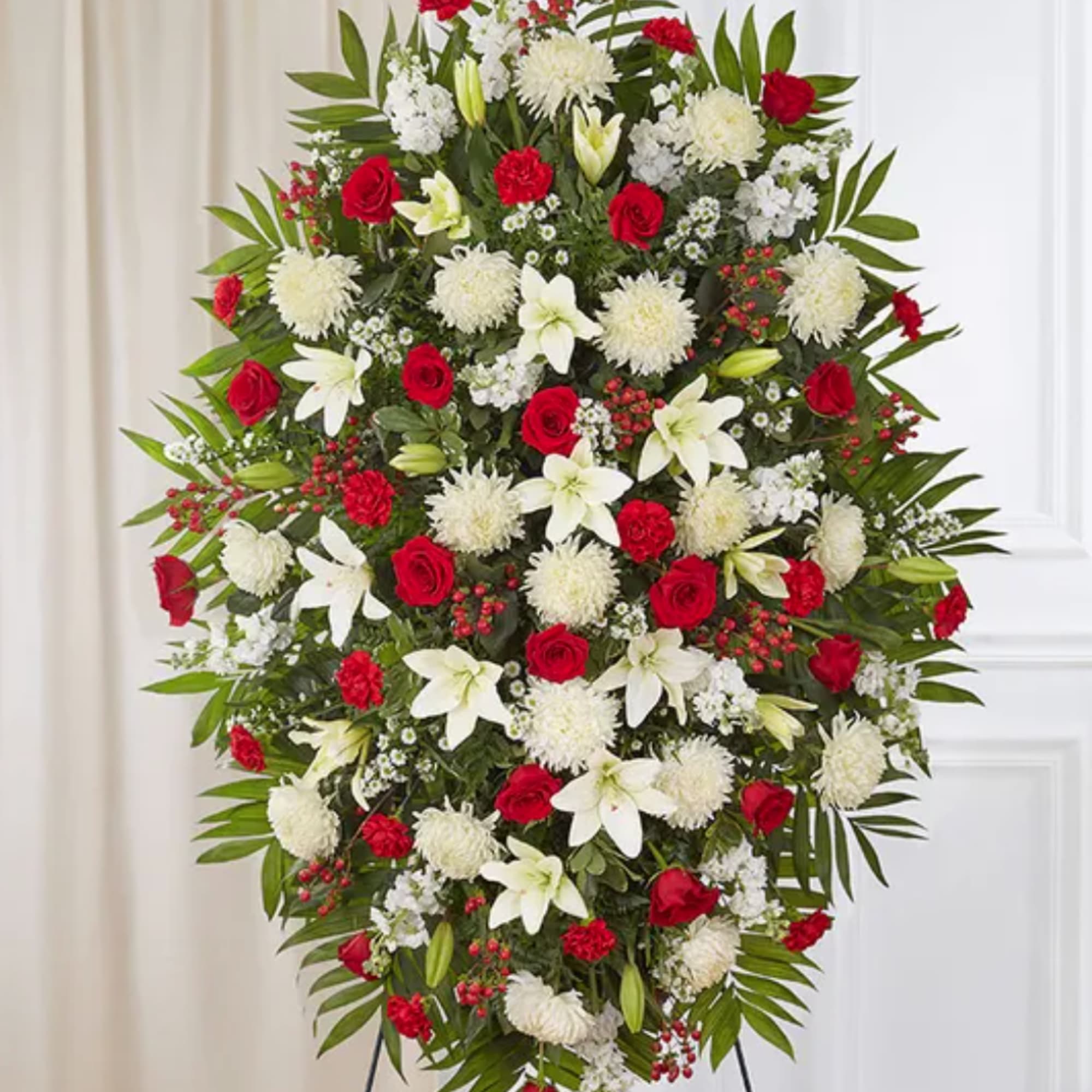 Large standing spray of red roses, white lilies, and white mums