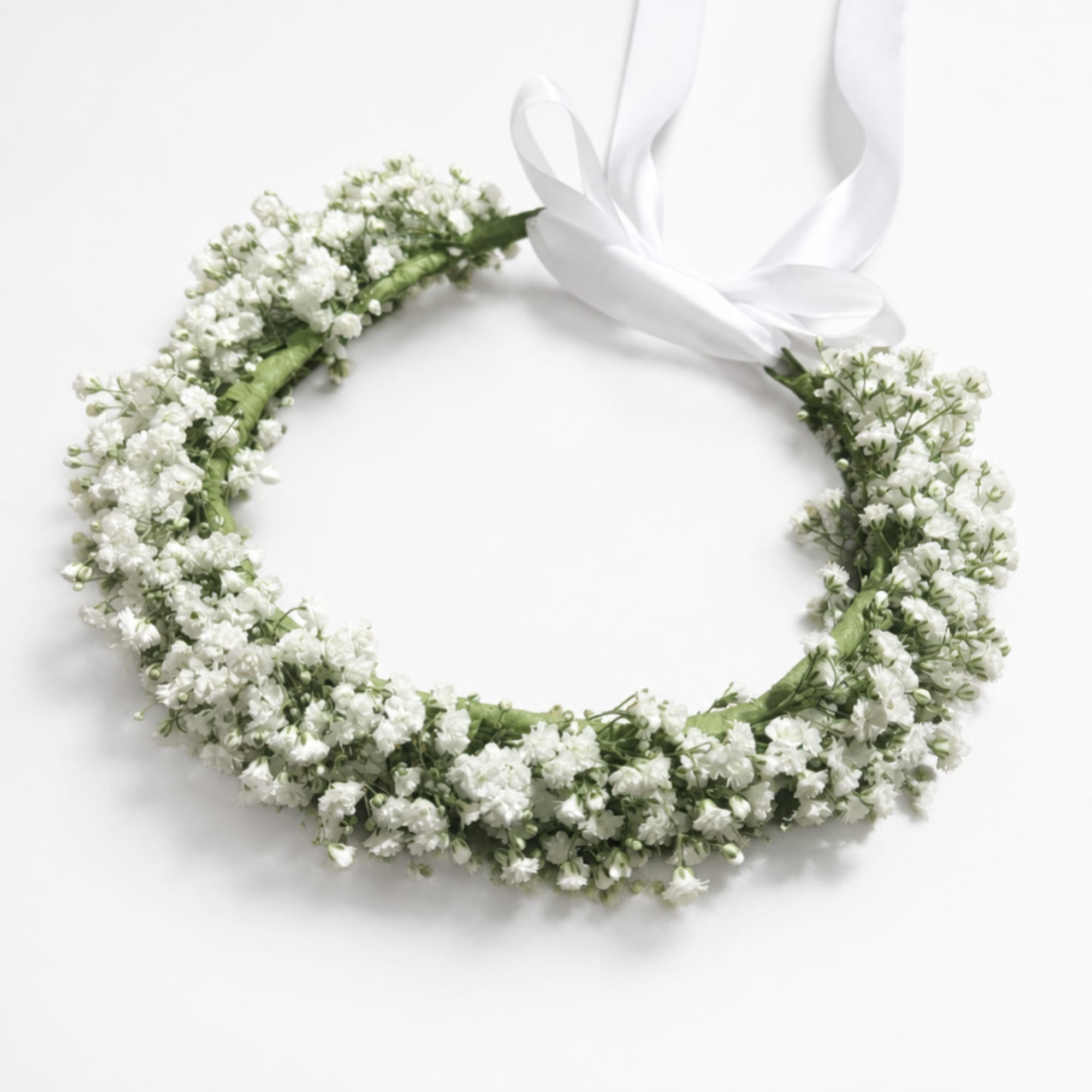 White floral wreath with a satin ribbon bow