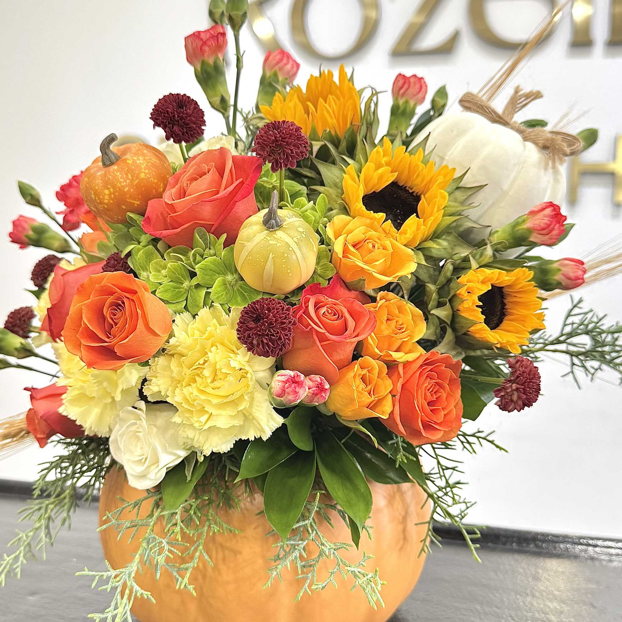 Celebrate the beauty of fall with our handcrafted Autumn Pumpkin Bloom Arrangement.