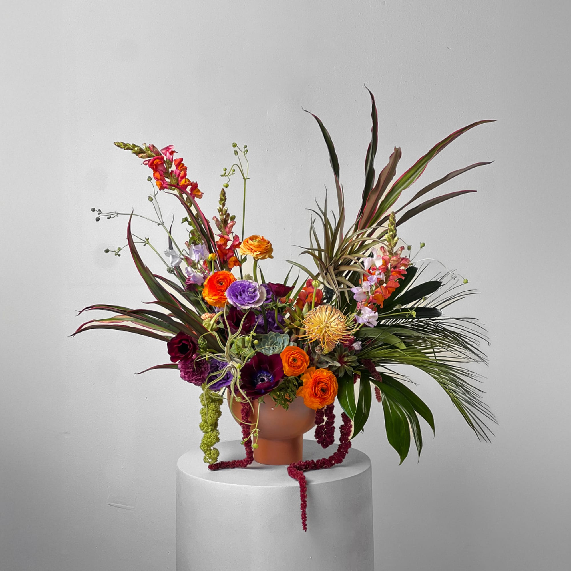 Colorful mixed floral arrangement in a terracotta vase