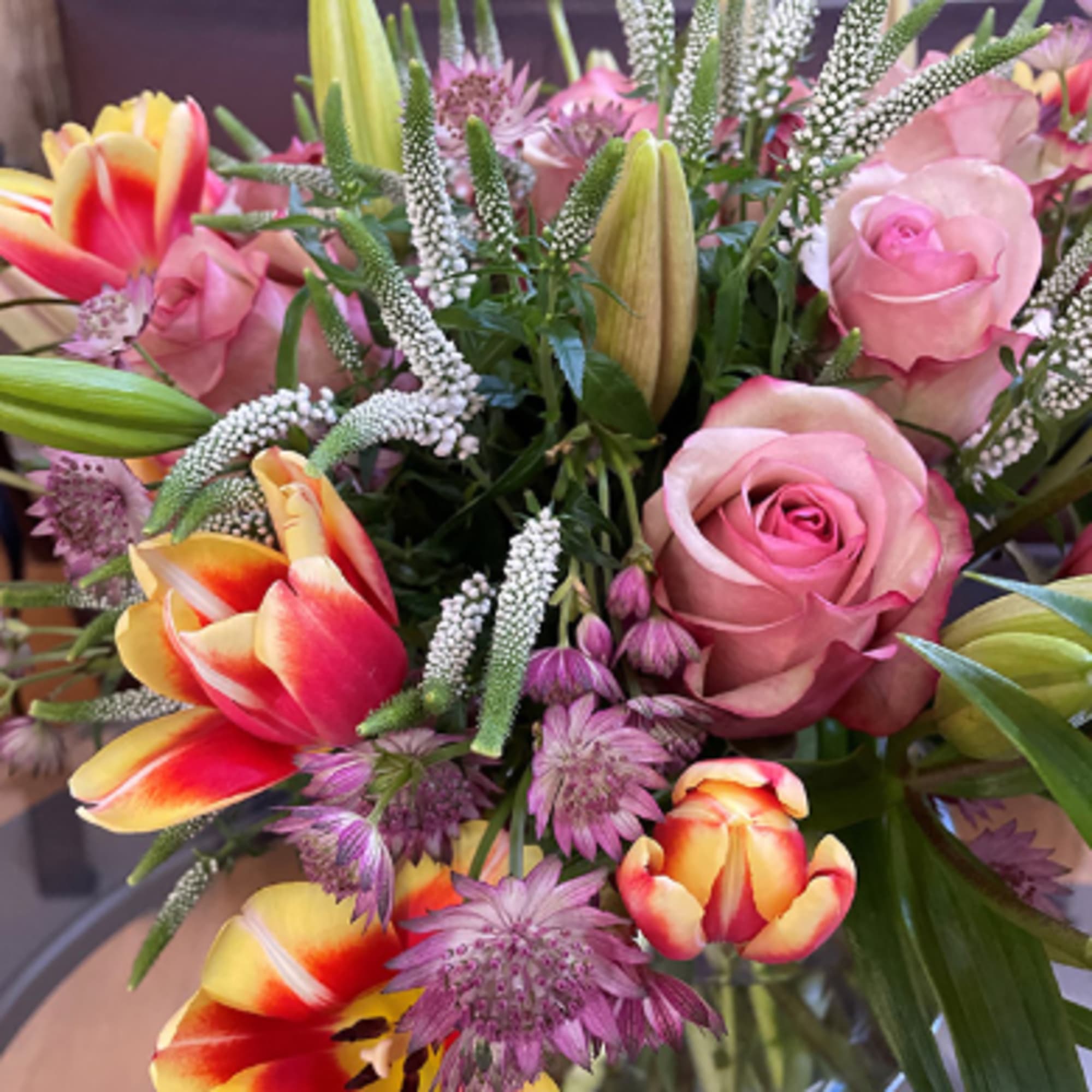 Bouquet of pink roses, tulips, and purple flowers