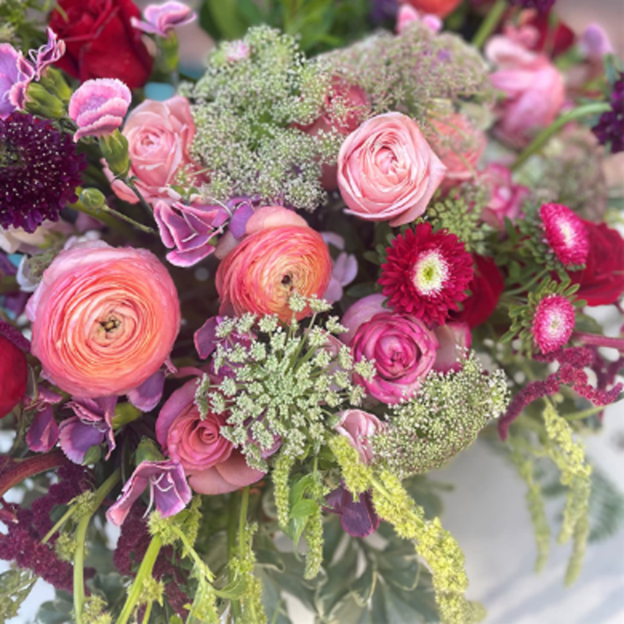 Bouquet of pink and purple flowers with airy filler blooms