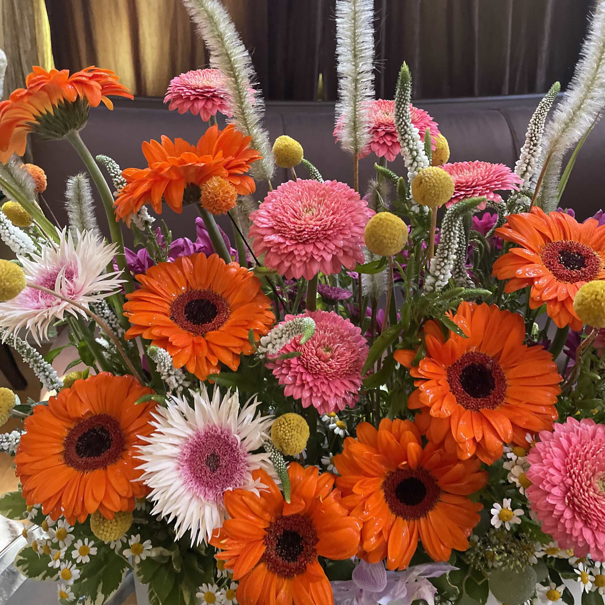 Bright mixed bouquet with orange gerbera daisies and pink blooms