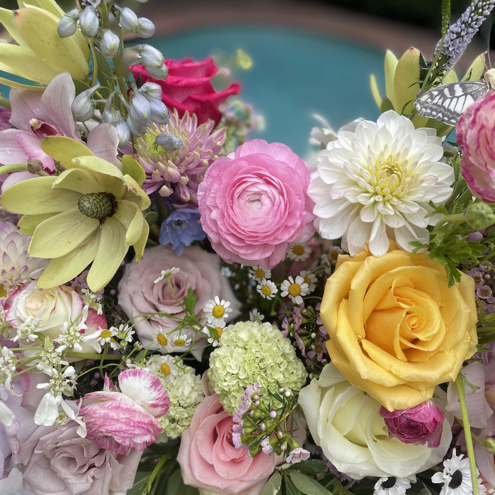 Mixed bouquet with roses, dahlias, and daisies in pink, yellow, and white