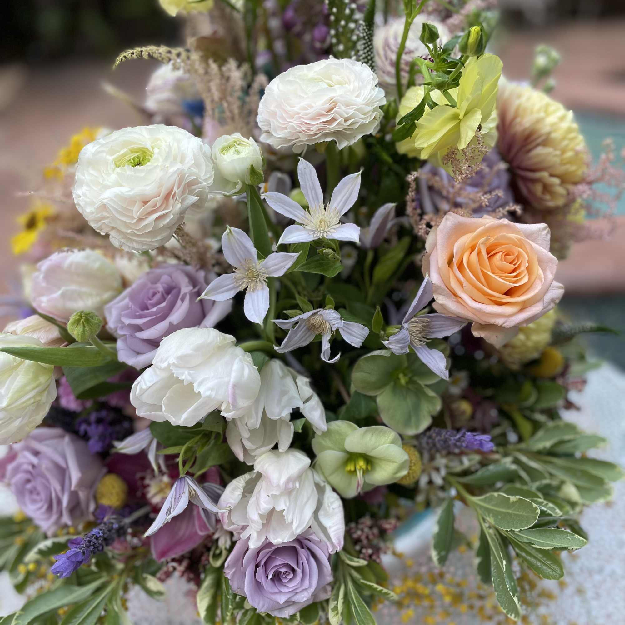 Mixed bouquet with pastel roses, white blooms, and lavender flowers