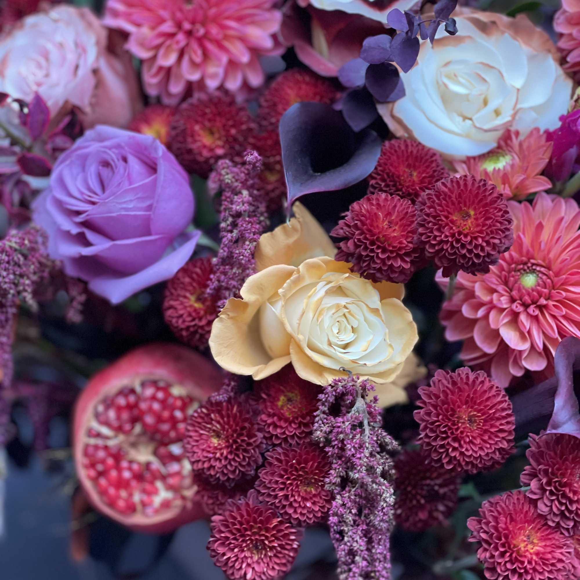 Bouquet of pink and cream roses with magenta pompon flowers