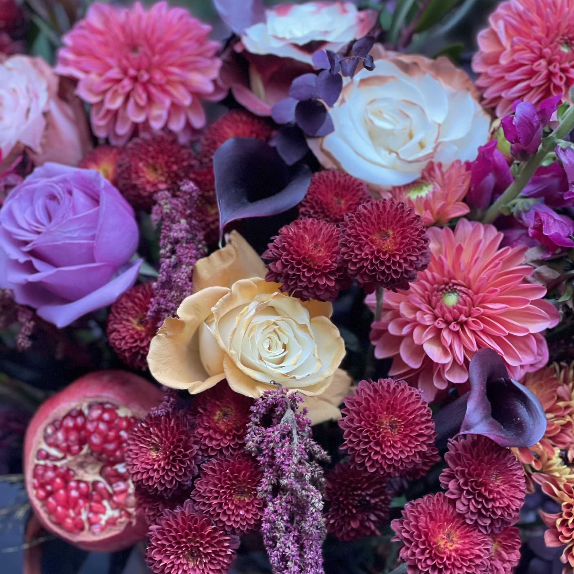 Mixed bouquet with pink and cream roses, dahlias, and dark calla lilies