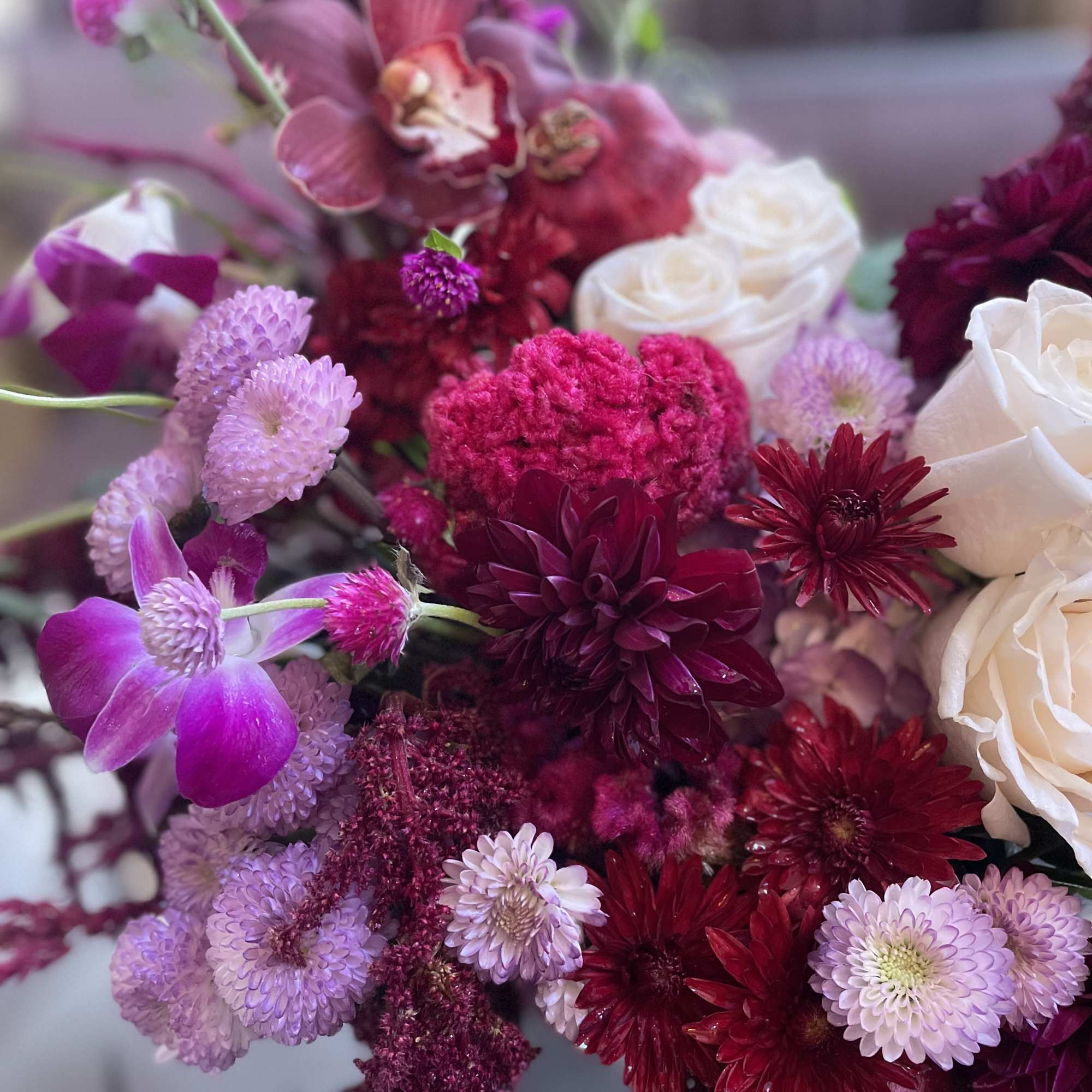 Bouquet of pink, burgundy, and white flowers in a close-up arrangement