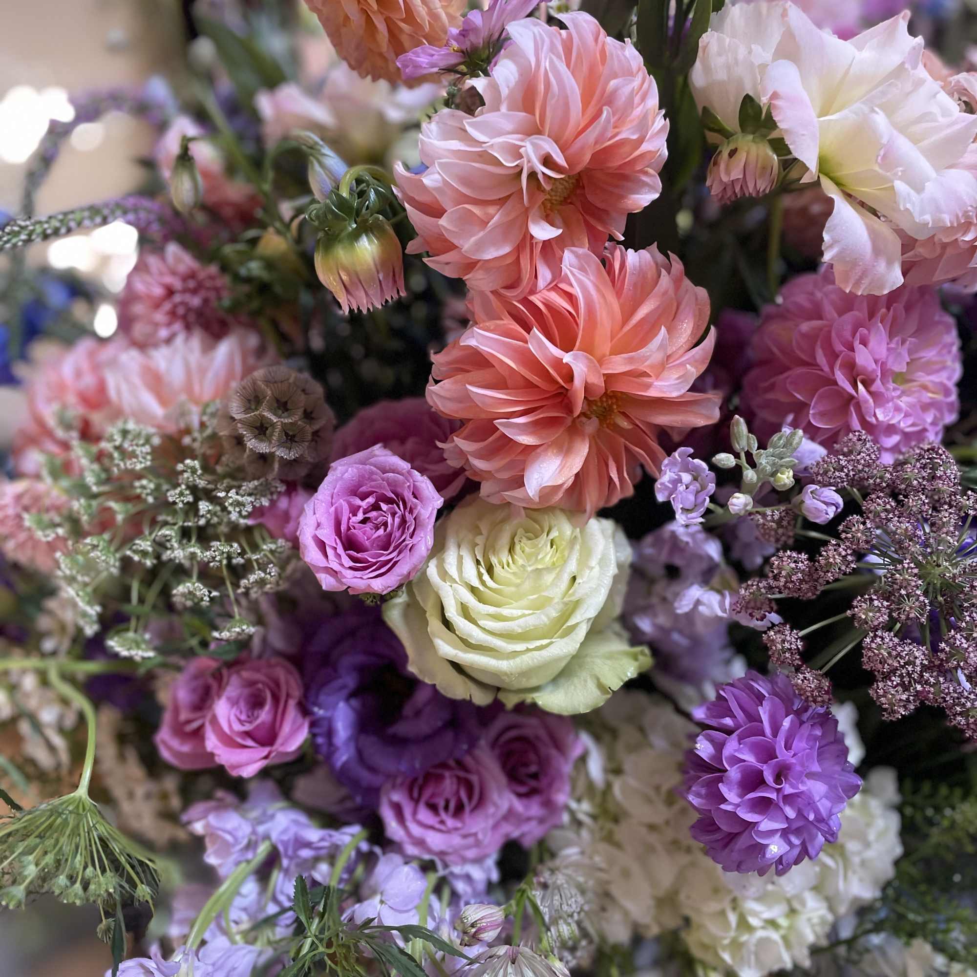 Bouquet of pink, purple, and white flowers with large dahlias and roses