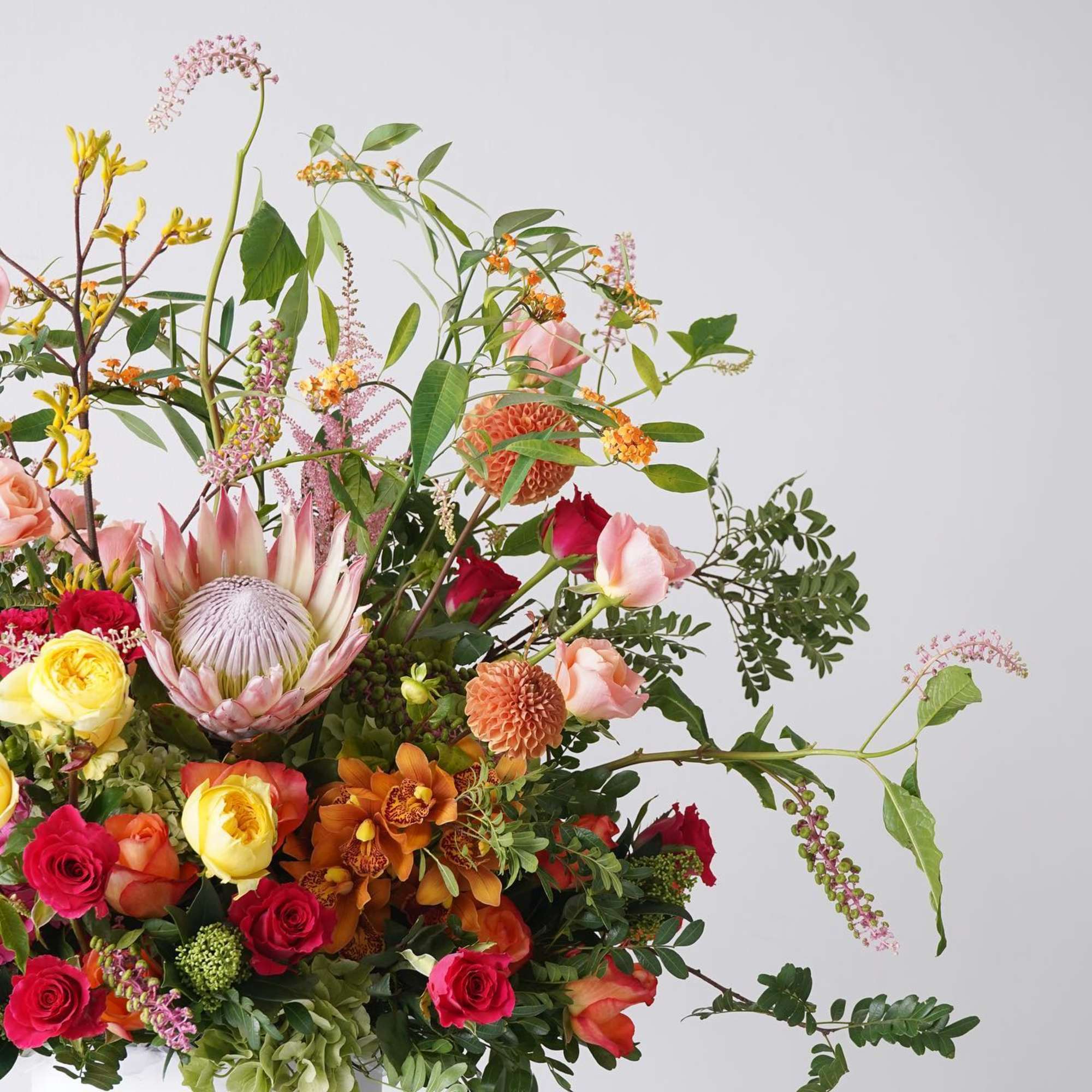 Large mixed bouquet with roses, orchids, and a protea bloom