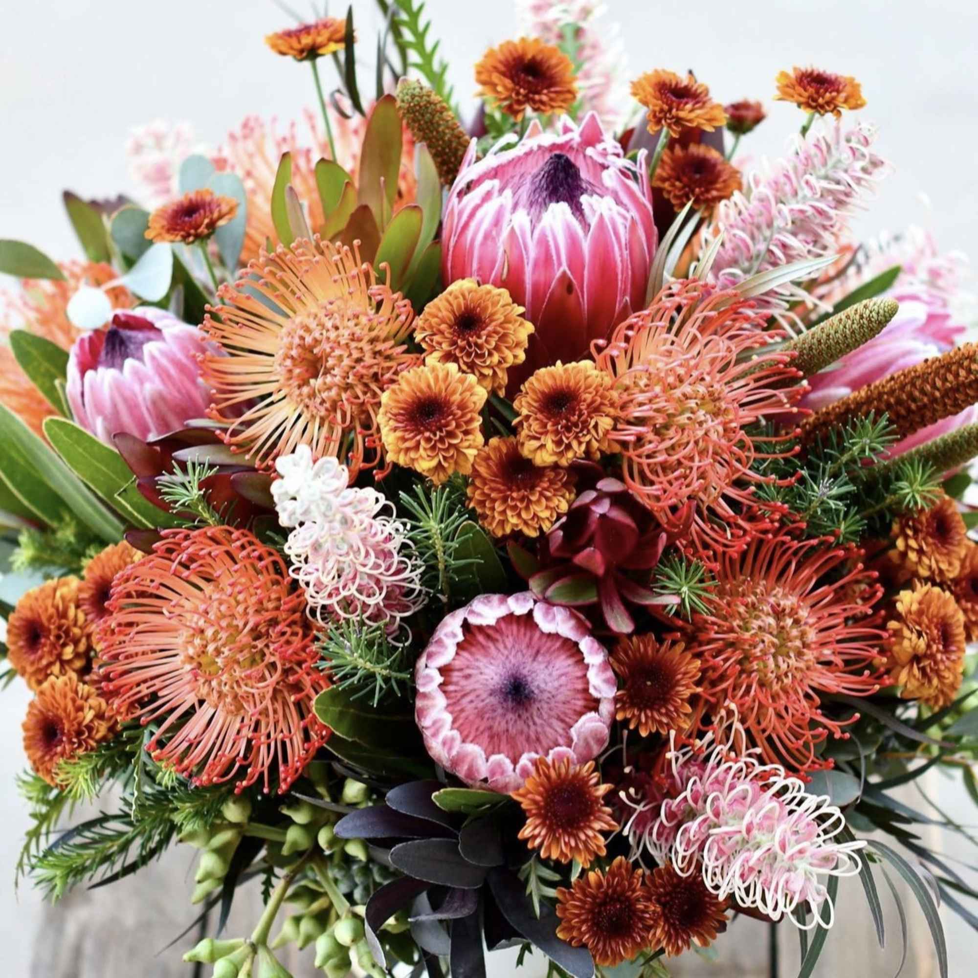Mixed bouquet with pink protea and orange pincushion flowers