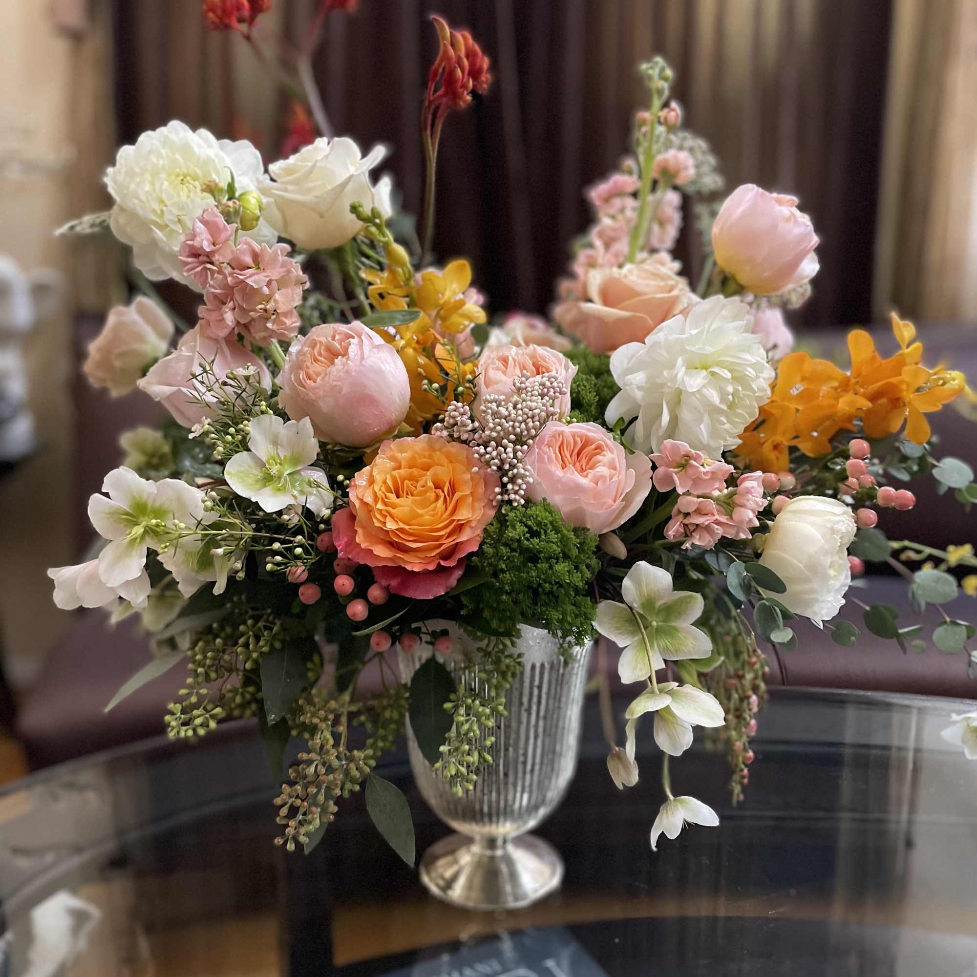 Mixed pastel flower arrangement in a silver vase