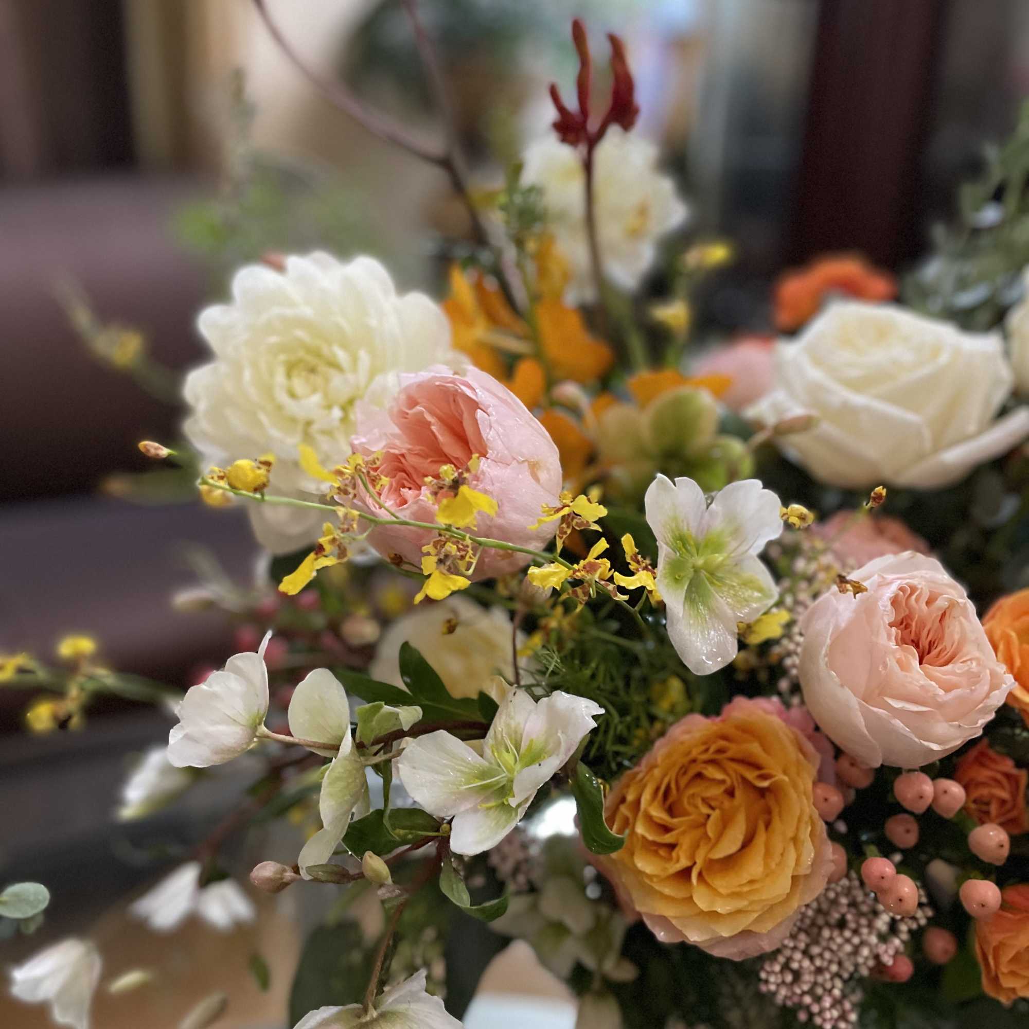 Mixed bouquet with pink, white, and orange flowers in a vase