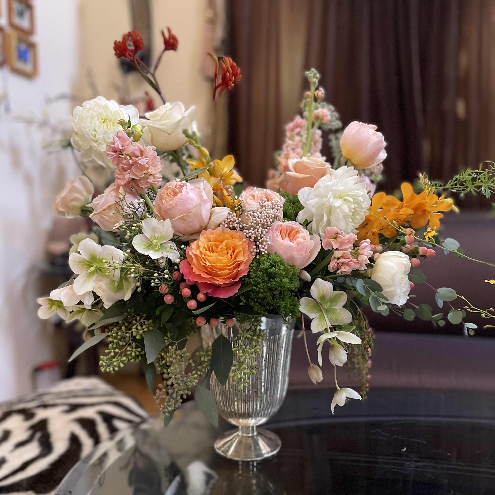 Mixed pastel flower arrangement in a clear glass vase